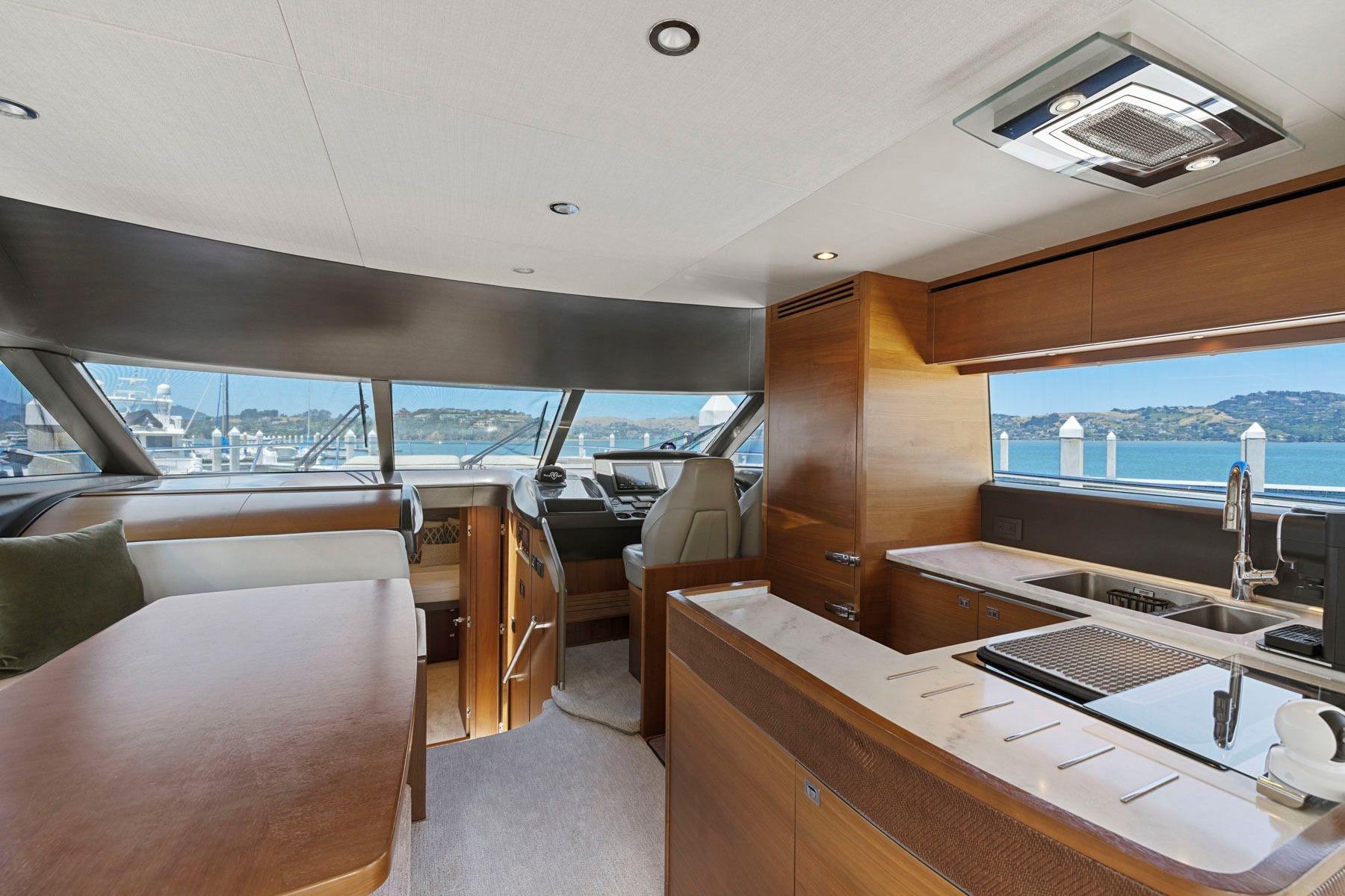 Luxurious interior of 2015 Princess 60 Flybridge Motor Yacht with modern kitchen and scenic views.