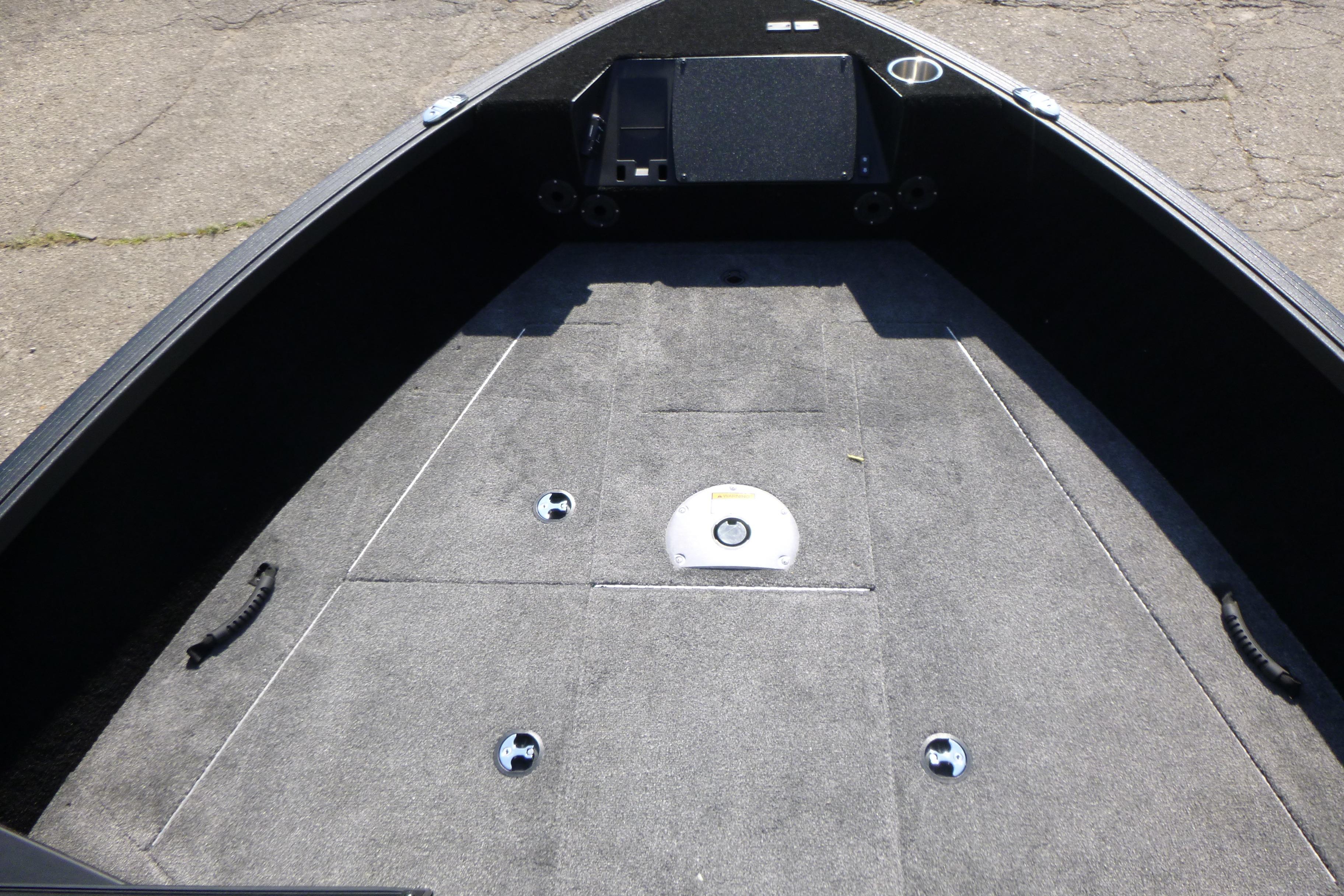 2024 Alumacraft Competitor 185X Sport boat interior with carpeted deck and storage compartments.