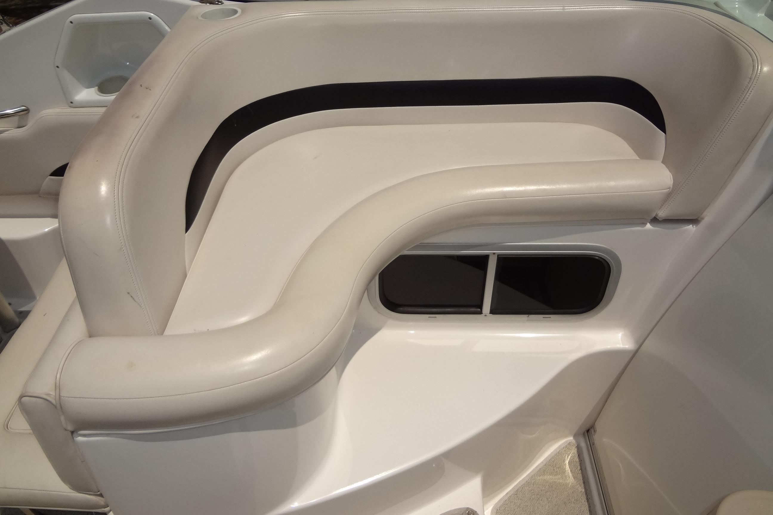 2000 Chaparral Signature 260 boat interior with white cushioned seating.