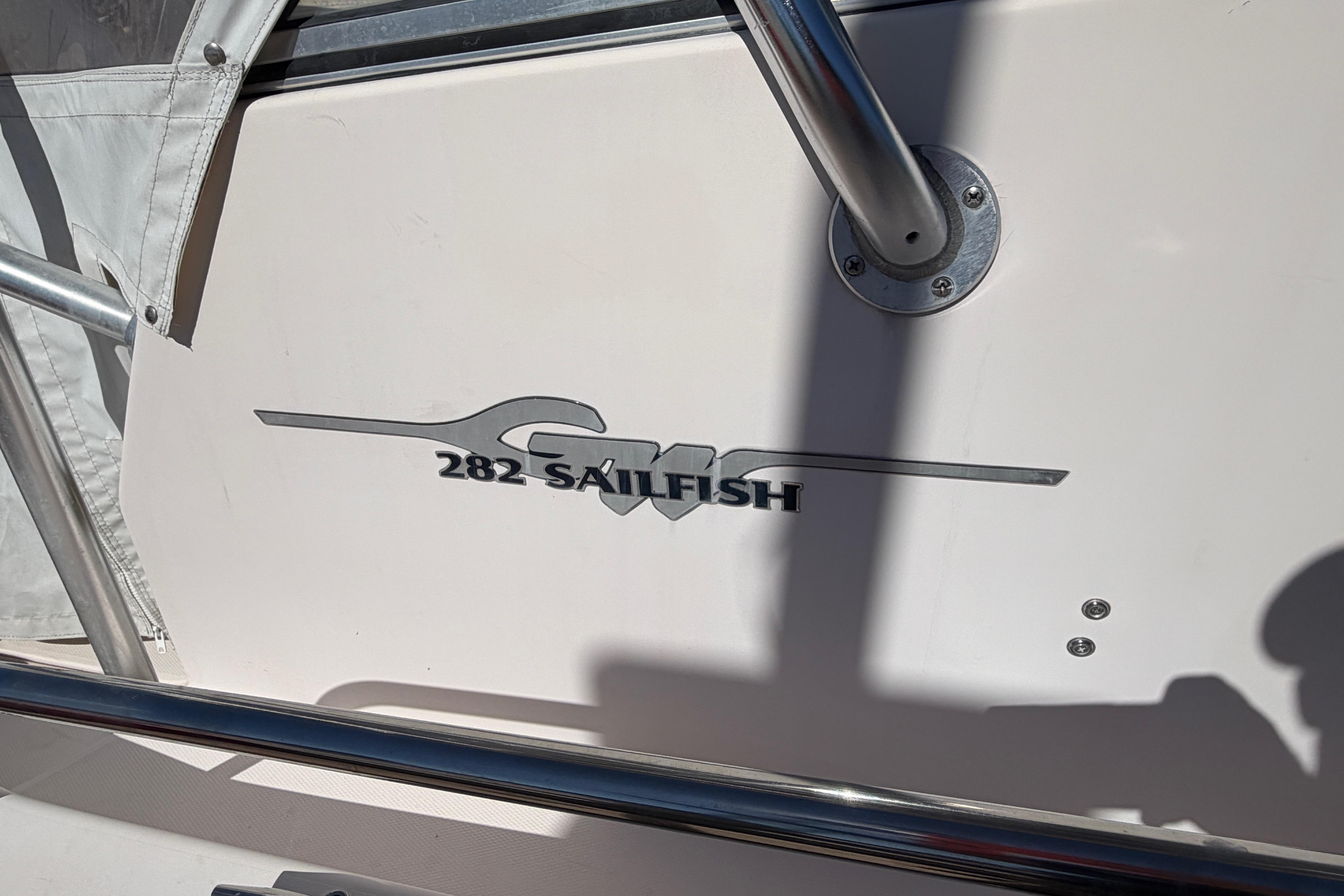 2006 Grady-White Sailfish 282 boat logo on white surface with metal railing.