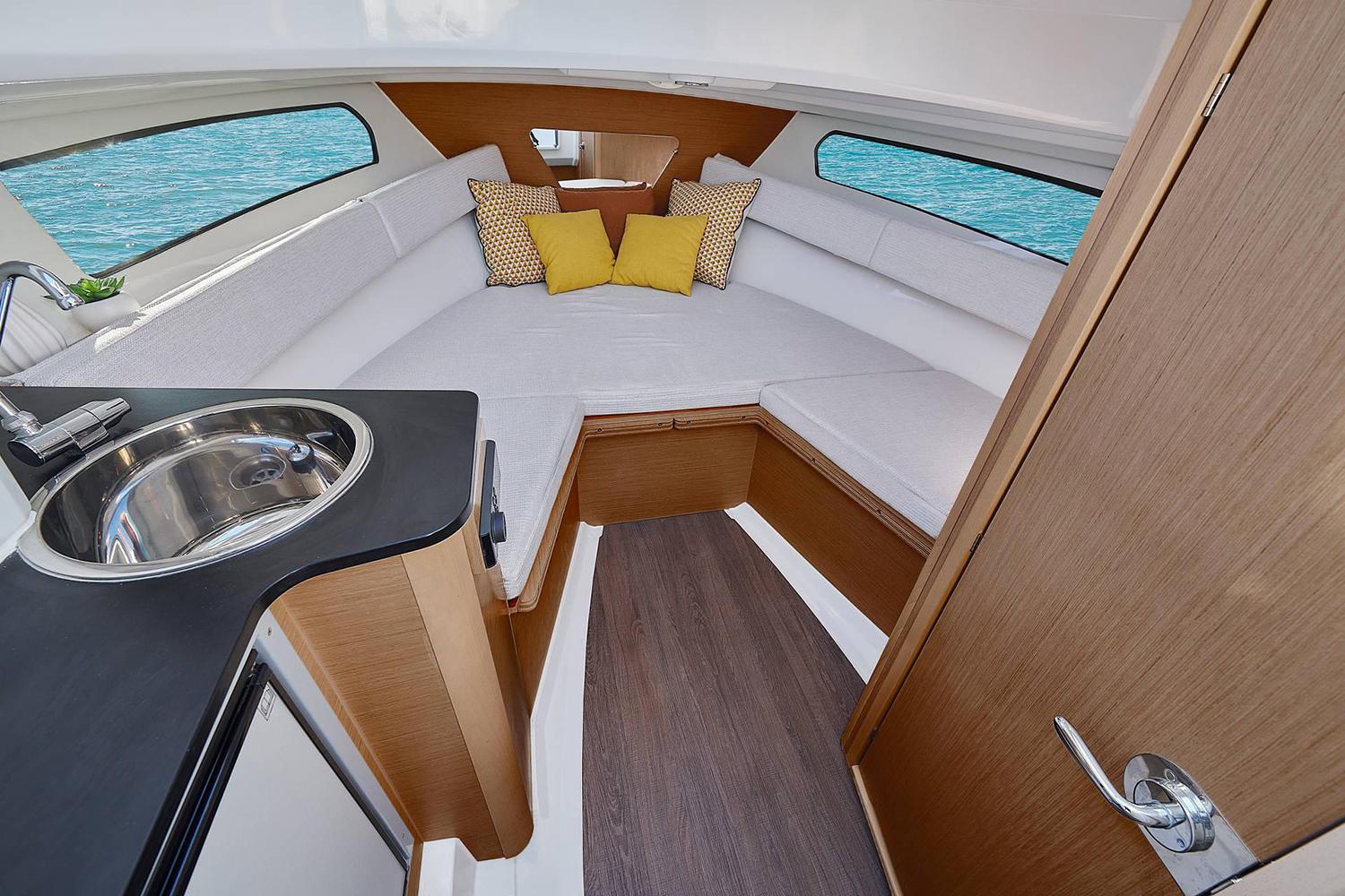 Manufacturer Provided Image: 2025 Jeanneau Leader 7.5 WA Series 3 cabin interior with seating, sink, and cushions.