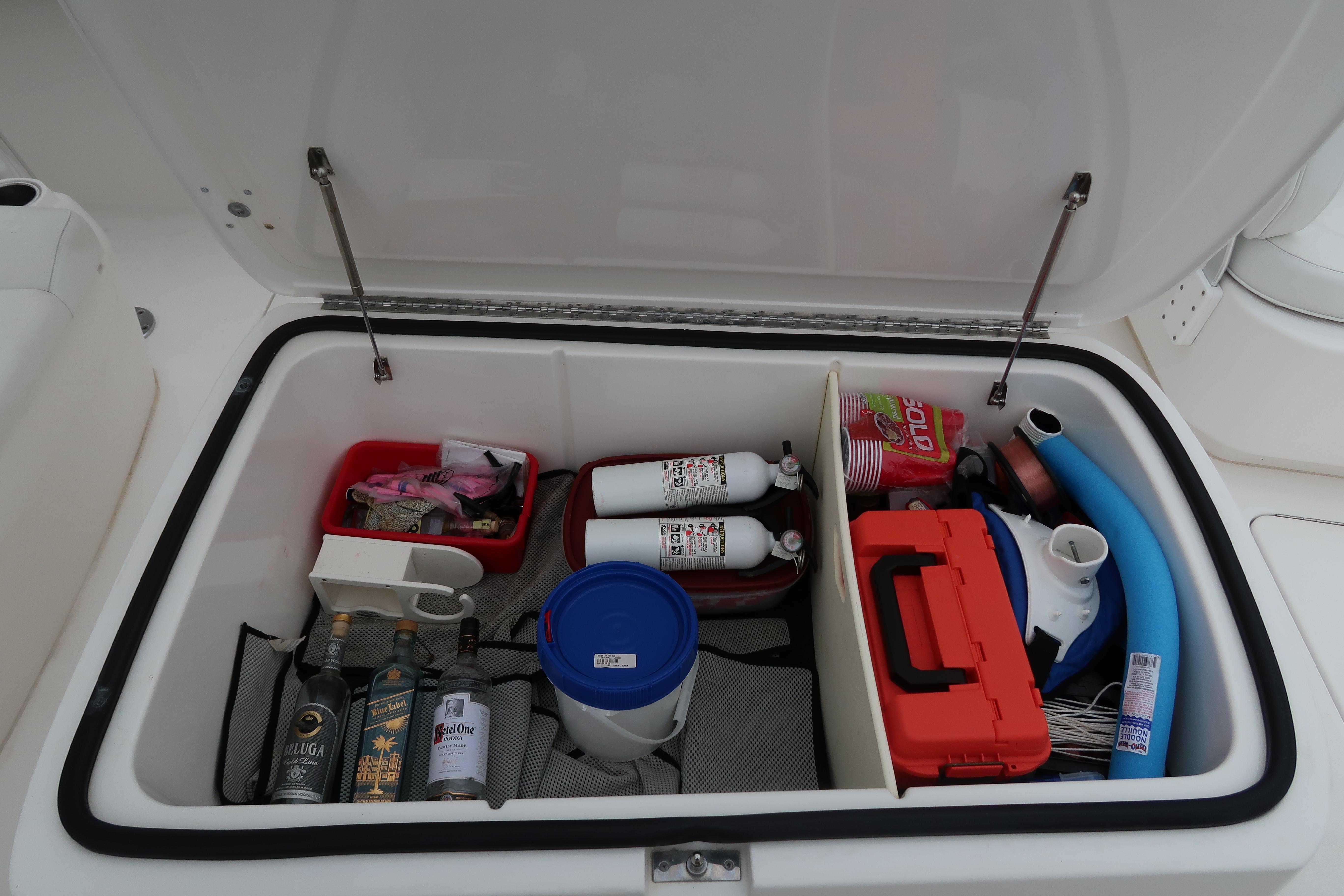 Storage compartment of a 2016 Invincible 42 Open Fisherman boat with various supplies.