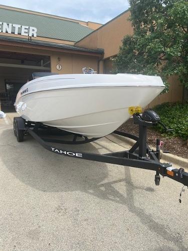 2025 Tahoe T21 boat on trailer outside a building.