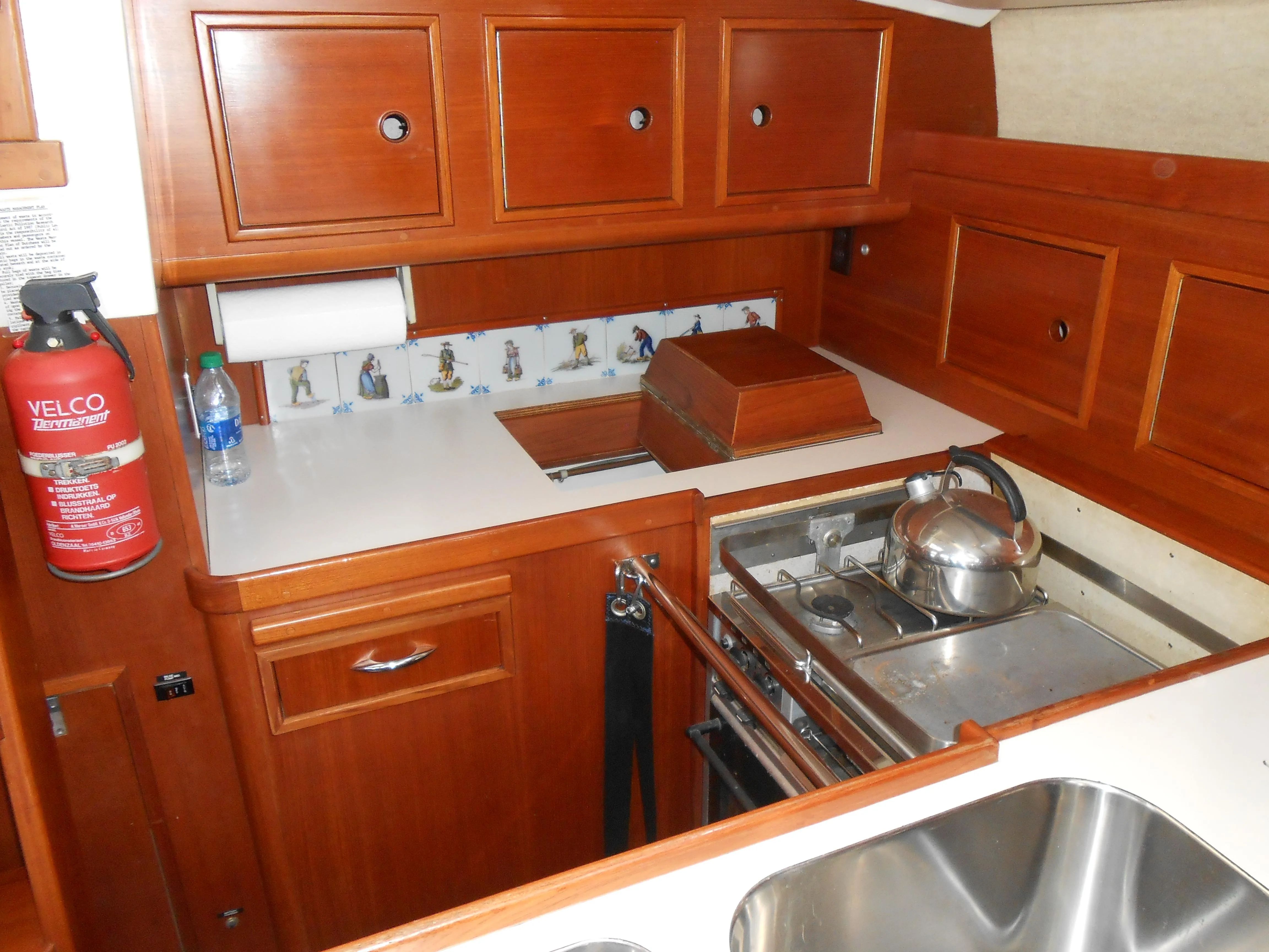 Galley of 1985 Contest 41 Ketch with wooden cabinets and stove.