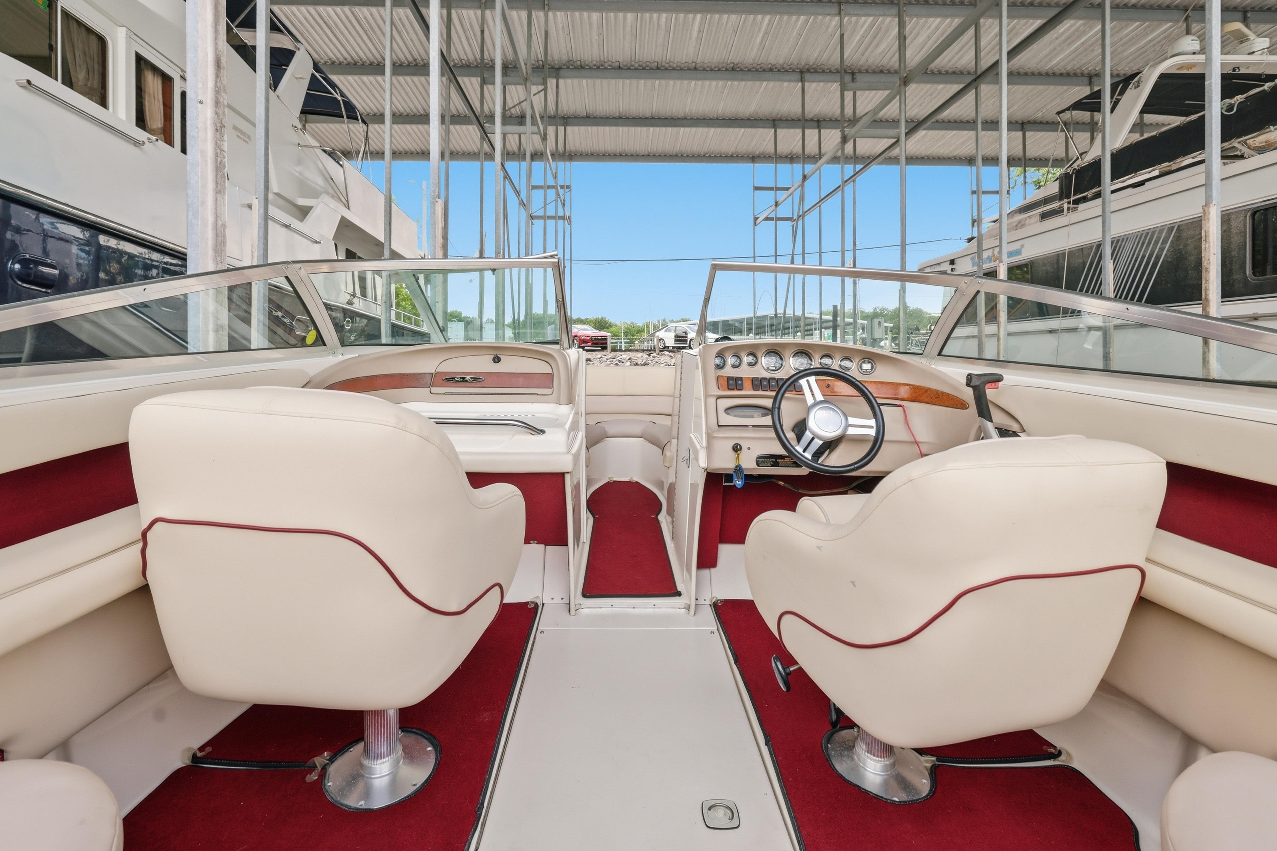 Interior of a 1997 Sea Ray 230 Signature boat with red and white seating.