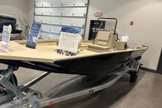 2026 G3 Bay 17 boat on display in showroom with promotional materials.