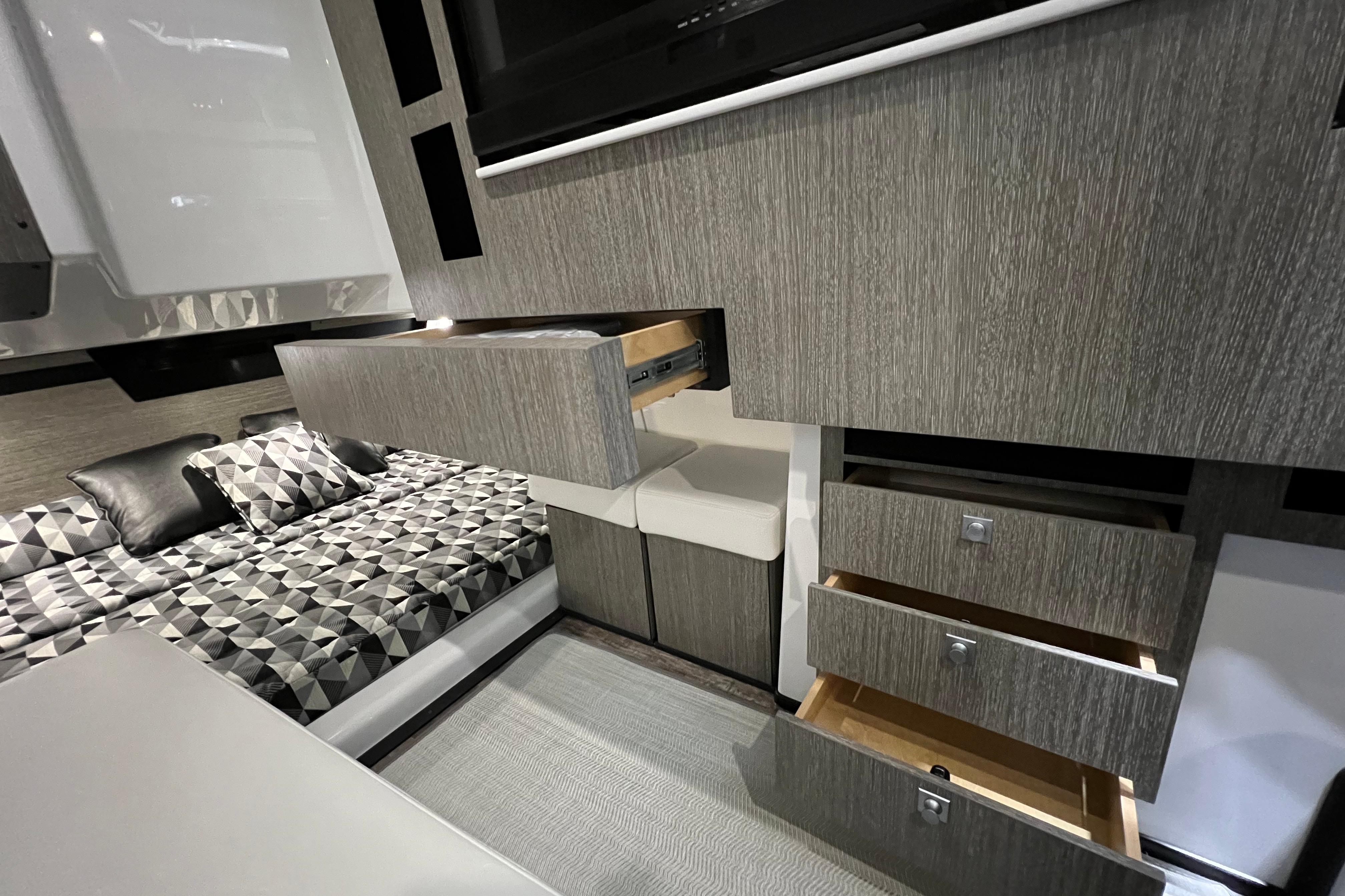 Interior of 2023 Monterey 378SS Super Sport with modern cabinetry and geometric-patterned bedding.