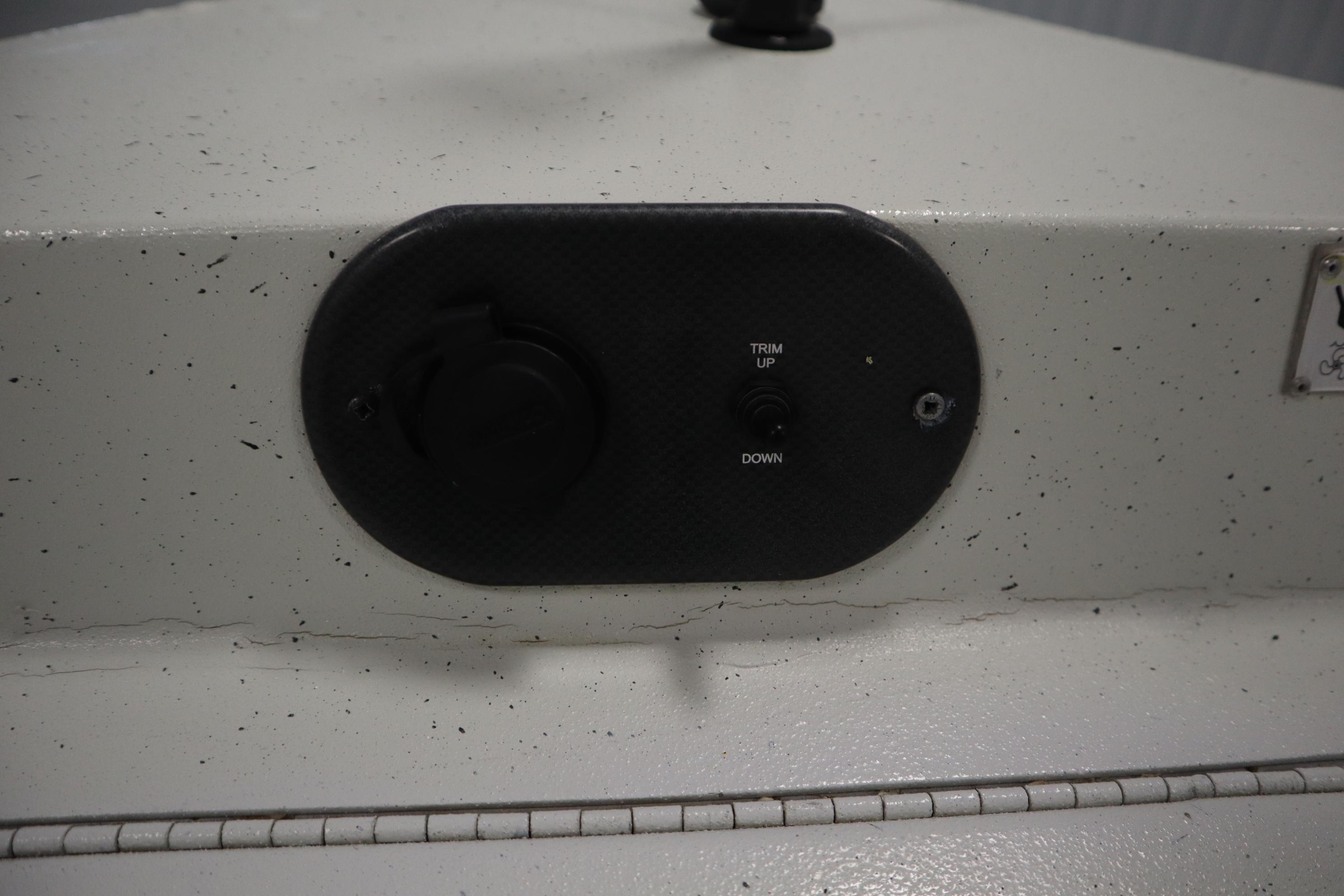 Control panel on 2022 Crestliner 2200 CC boat with trim adjustment switch.
