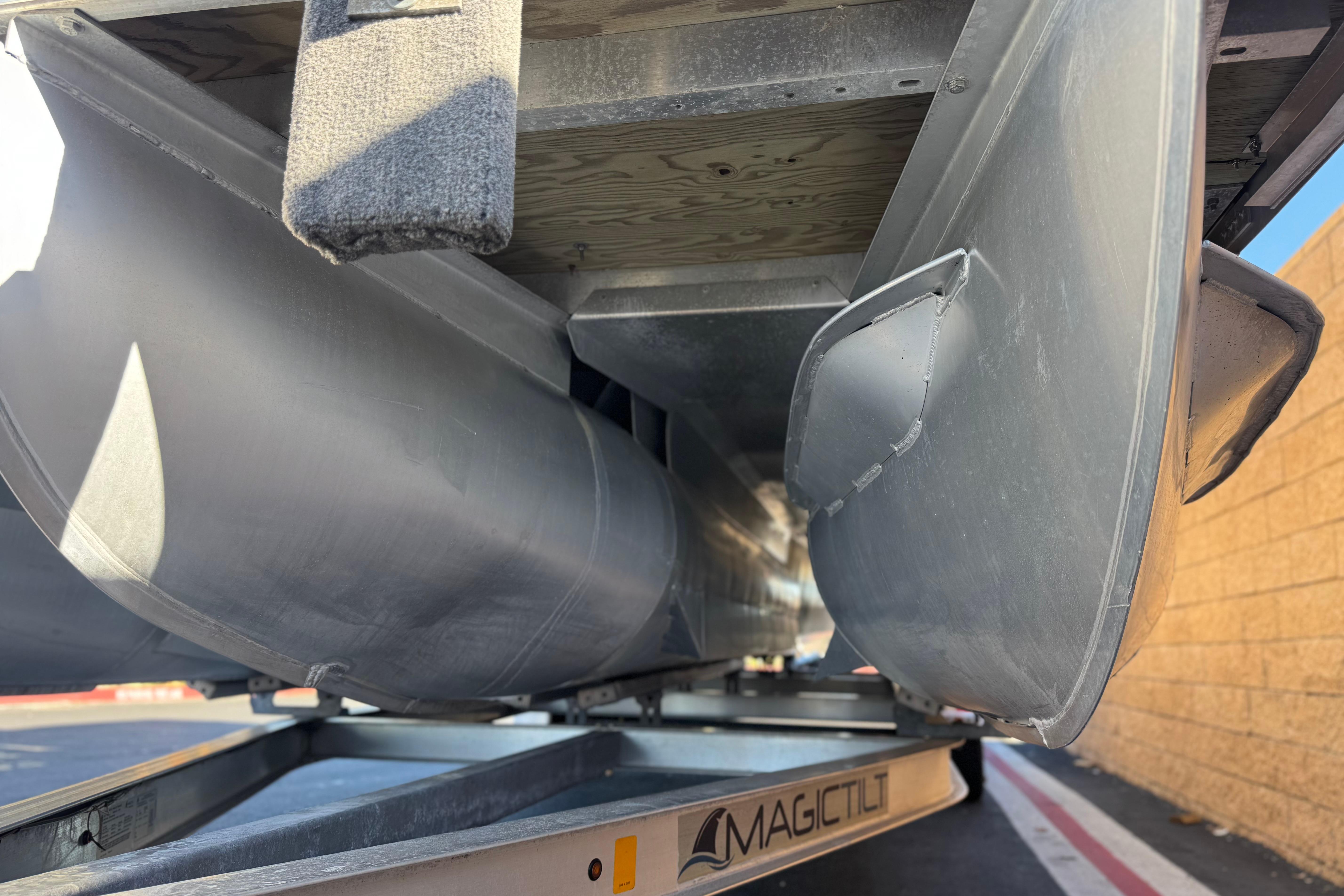 2013 Bennington 2575QCW I/O pontoon boat underside on Magic Tilt trailer.