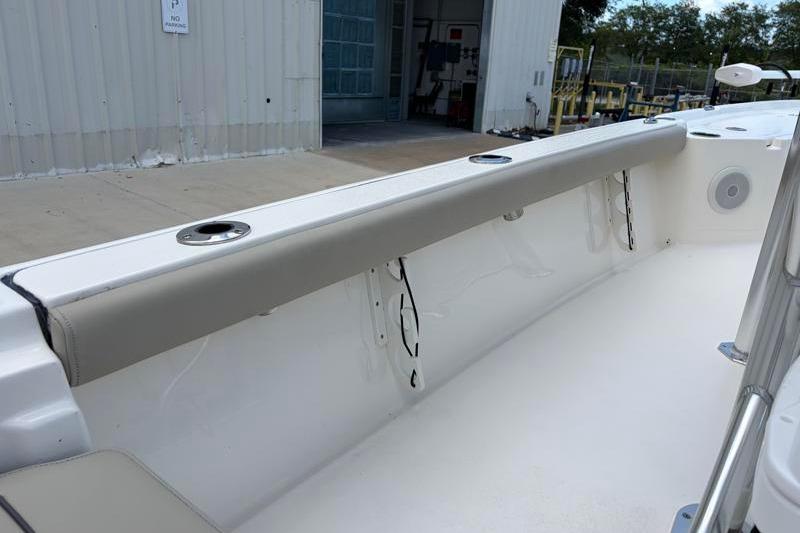 2025 Key West 210 Bay Reef boat interior with cushioned seating and cup holders.