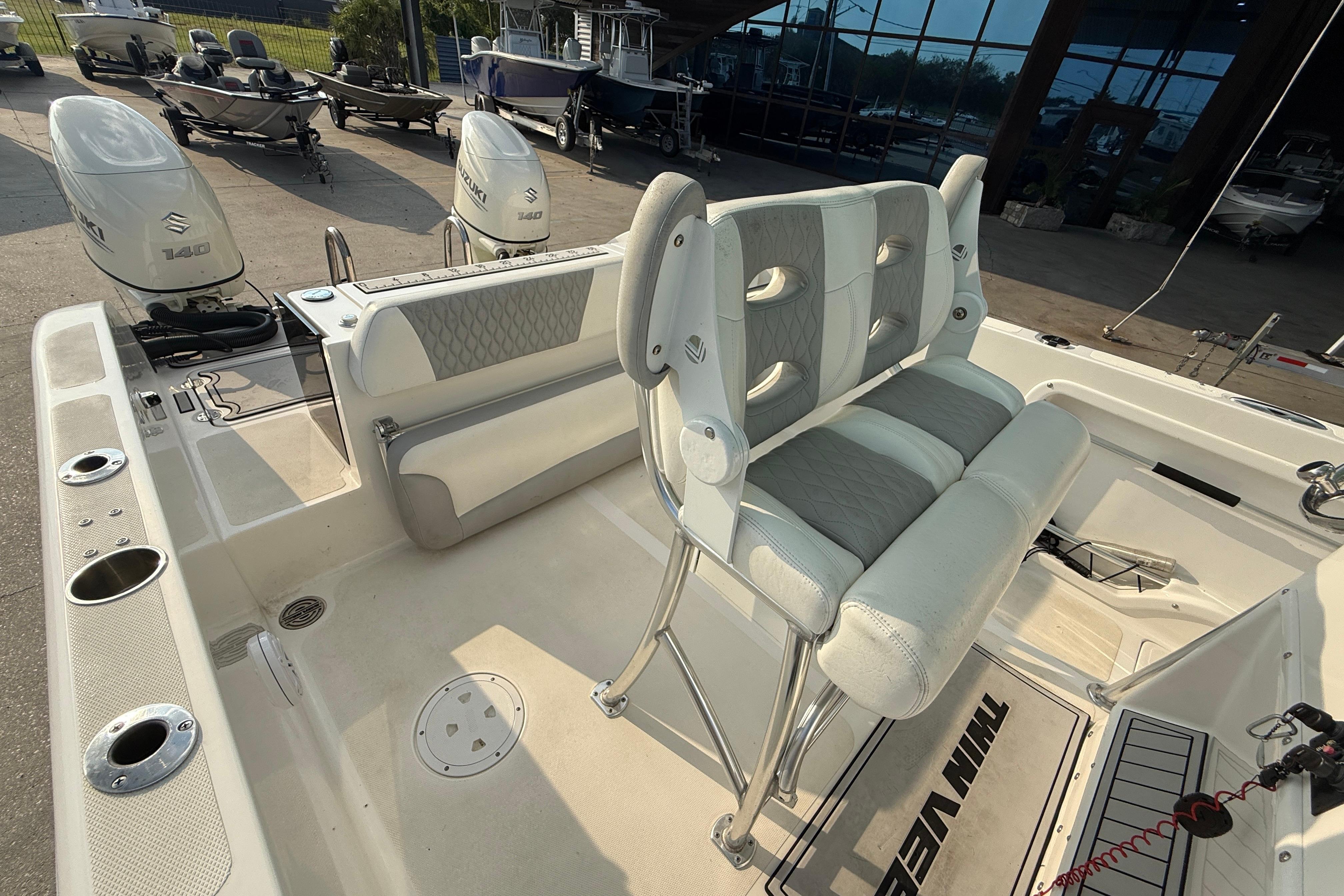 2020 Twin Vee 240 GFX CC boat interior with dual Suzuki engines and cushioned seating.