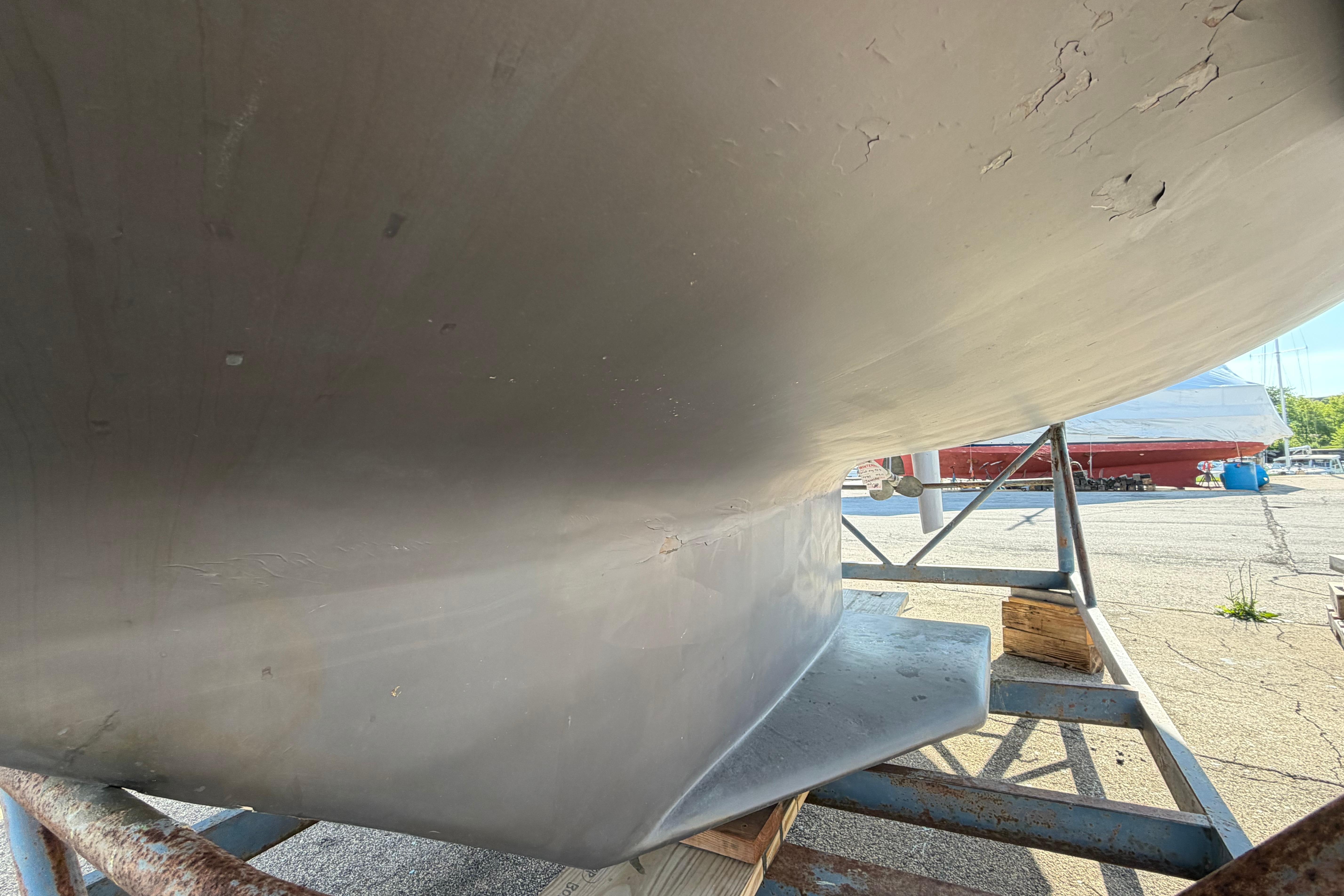 1988 Catalina 30 MkII sailboat hull on a stand, showing keel and propeller.