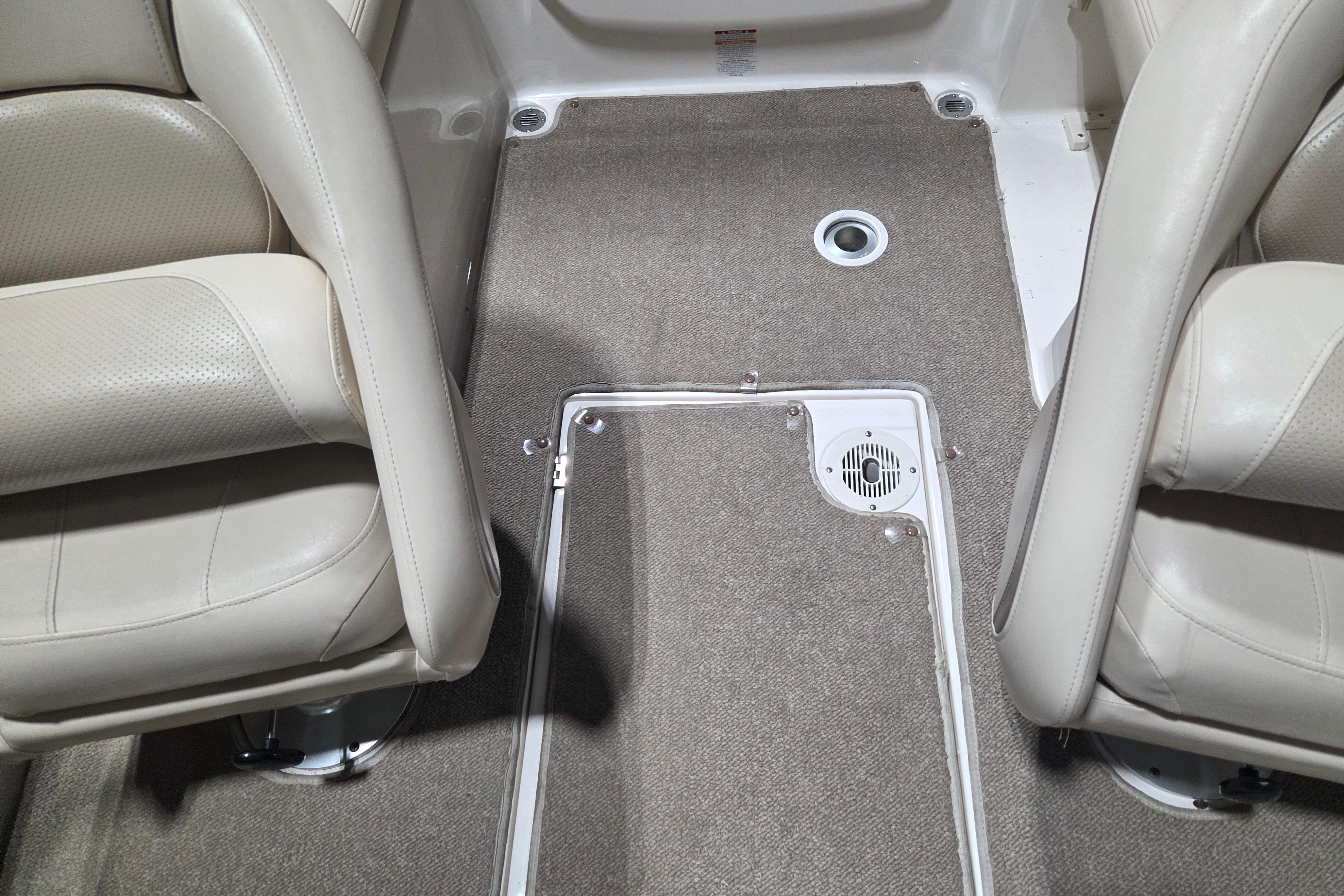 Interior of 2006 Chaparral 236 SSi boat with beige seating and carpeted floor.