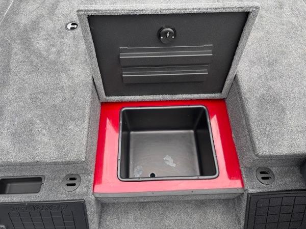 Storage compartment in 2025 Tracker Savage 215 boat, featuring a red and black interior.