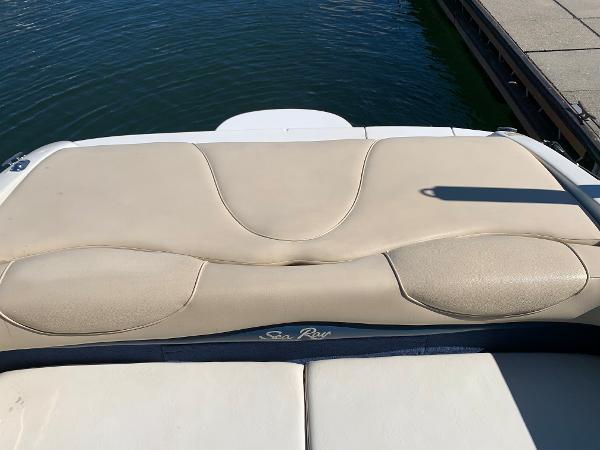 Sea Ray 210 Bow Rider 2000 boat's rear seating area by the water.