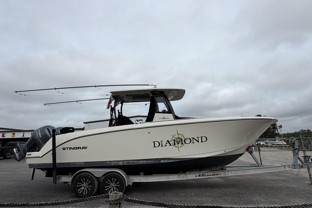 2023 Stingray 273 CC boat named "Diamond" on a trailer, overcast sky.