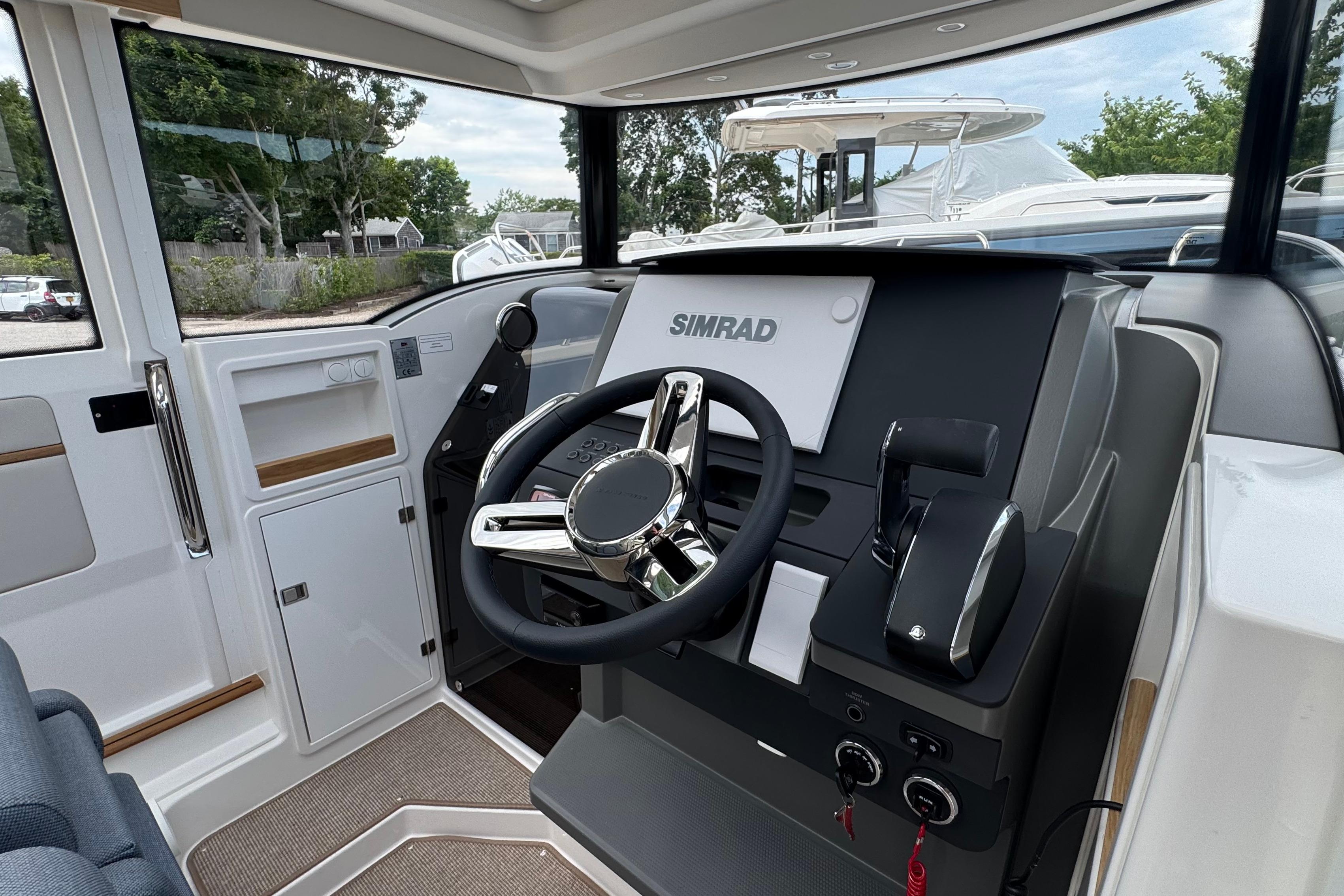 The image shows the helm of a 2026 Nimbus Commuter 9 boat with a Simrad display.