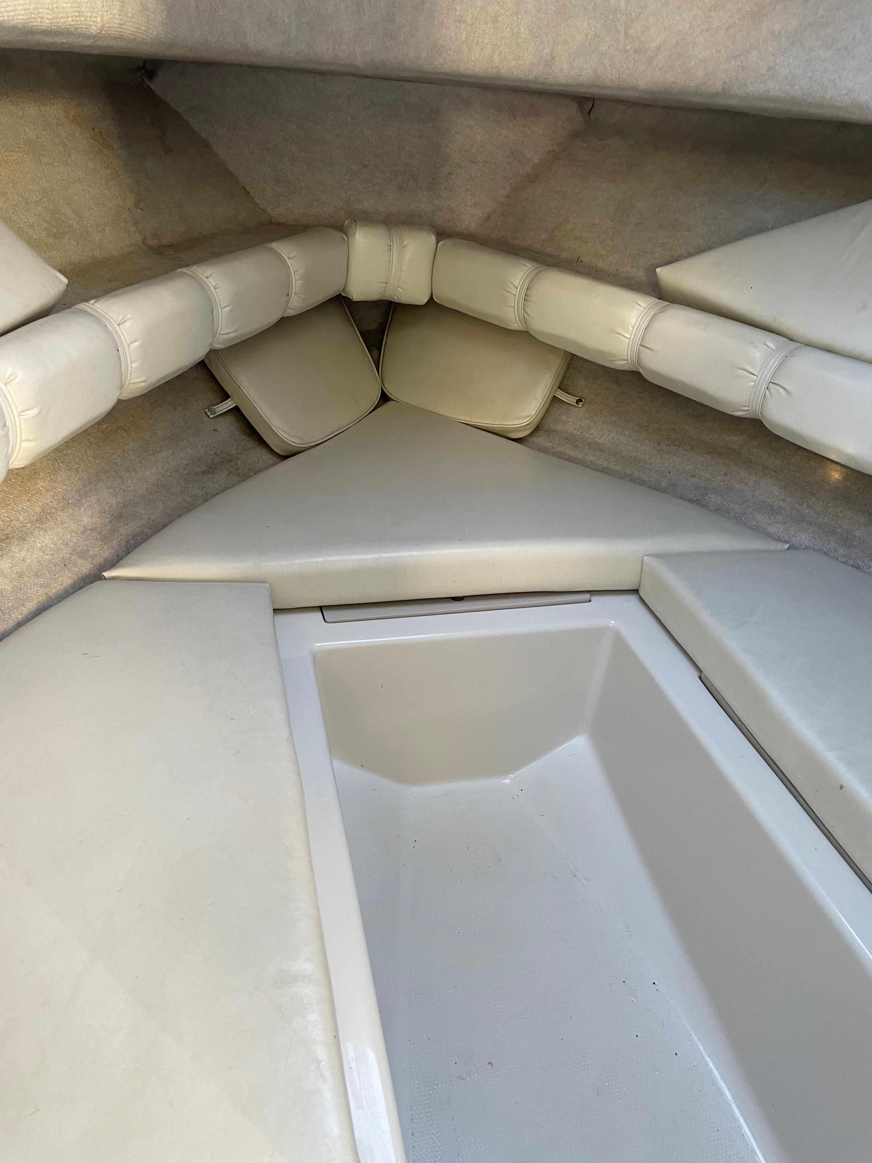 The image shows the interior of a 2001 Bluewater 2100 Sport Fisher with cushioned seating.