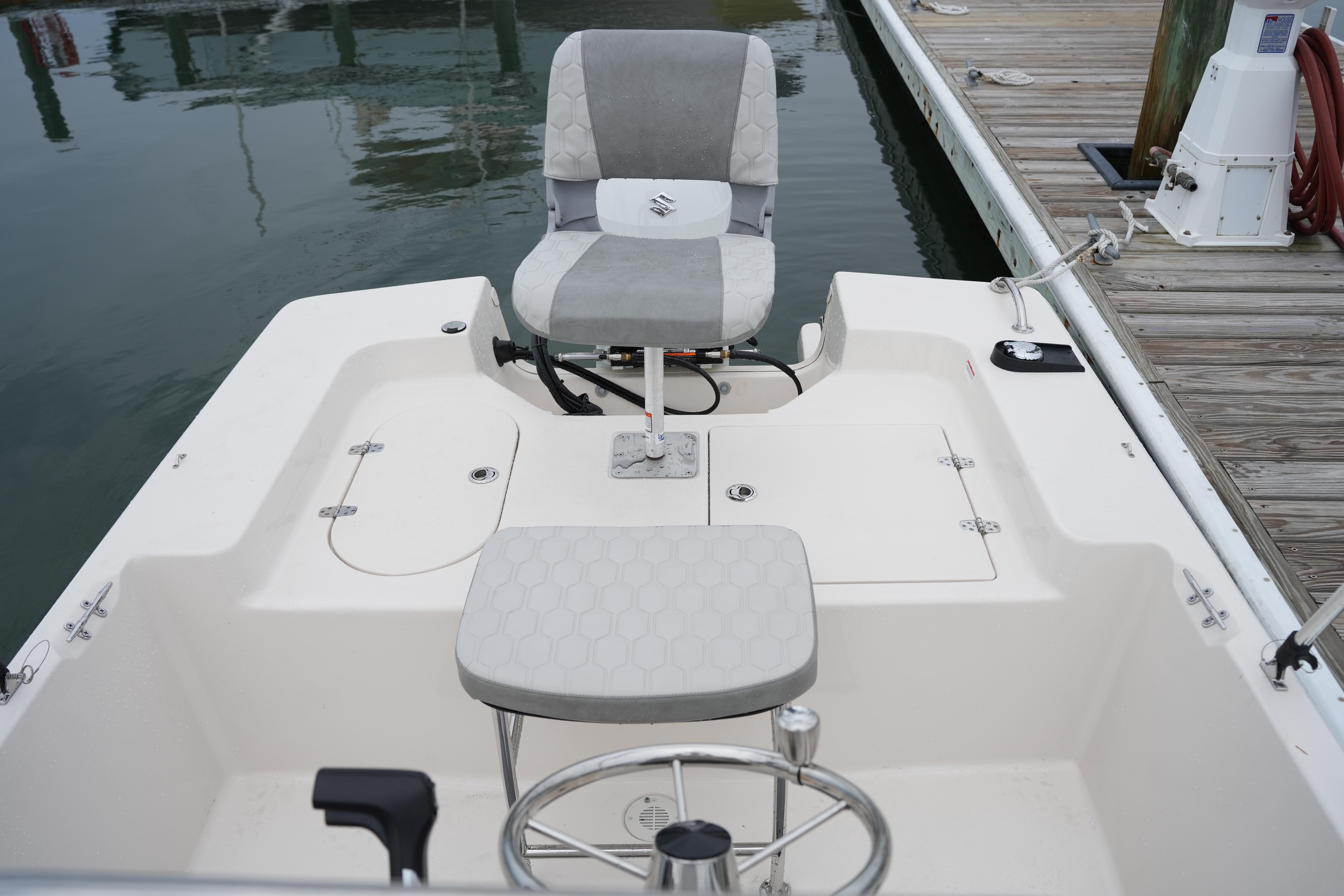 2025 Carolina Skiff 162 JLS boat interior with seating and storage compartments.