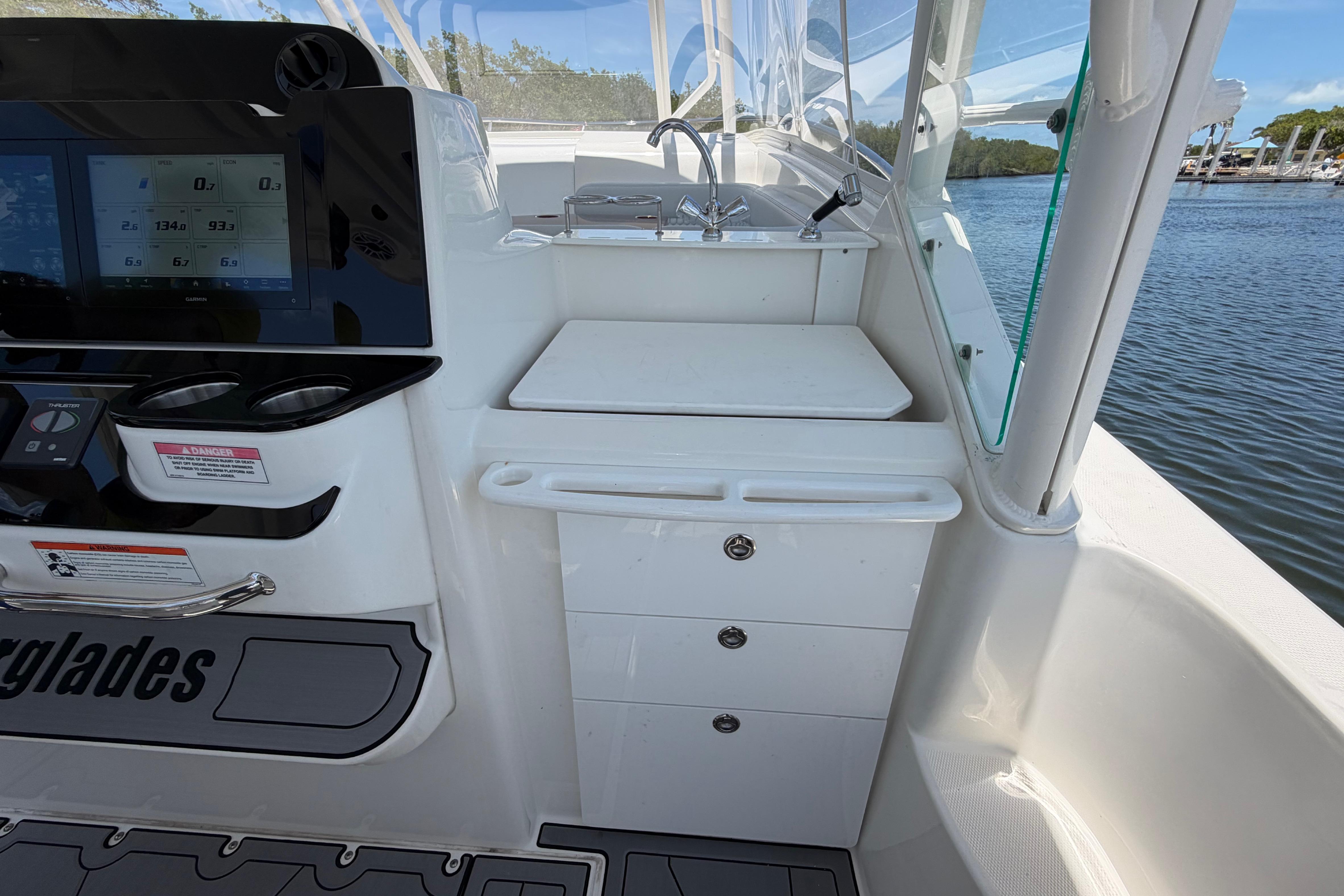 Interior view of a 2009 Everglades 350LX boat with control panel and sink.