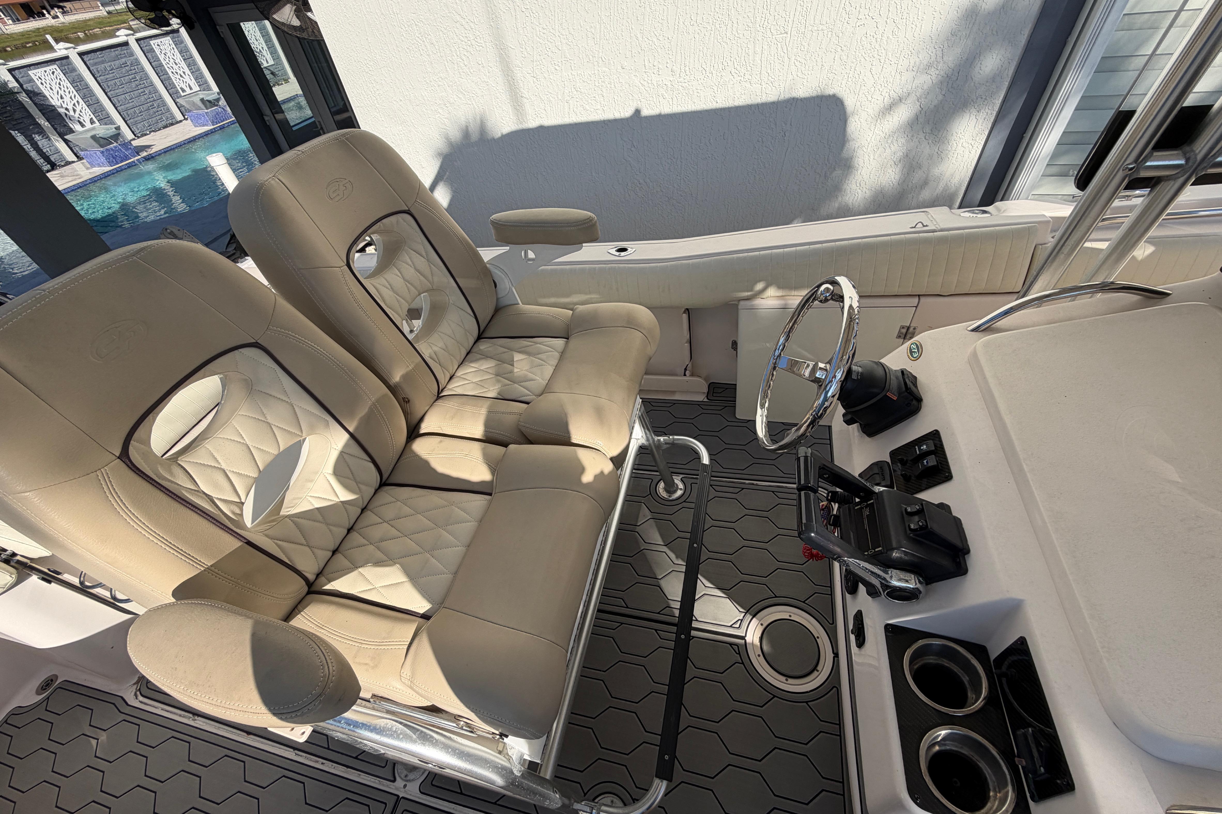 2004 Grady White 273 boat interior with beige seating and steering wheel.