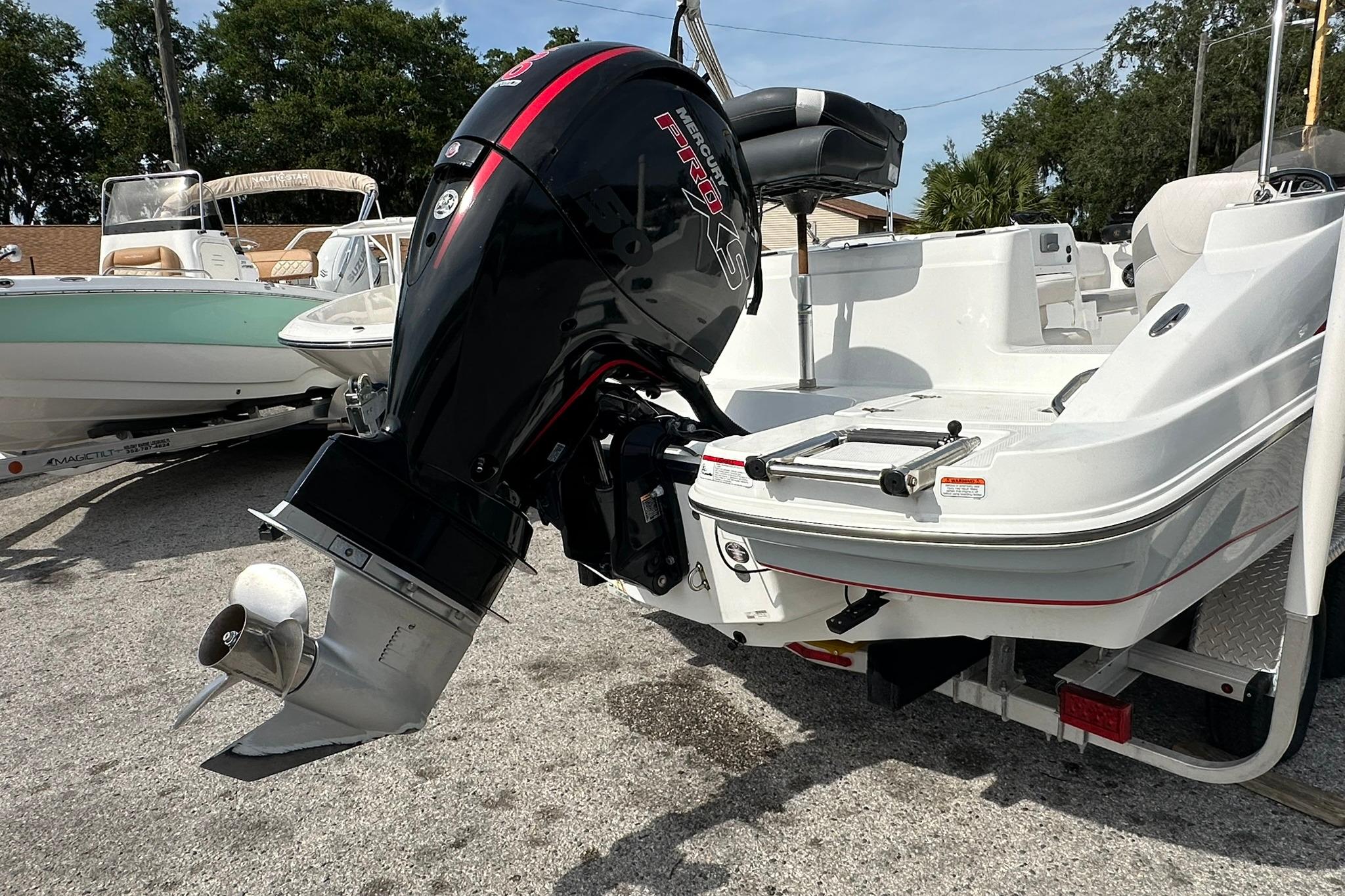 2021 Tahoe 2150 boat with Mercury Pro XS outboard motor, parked on a trailer.