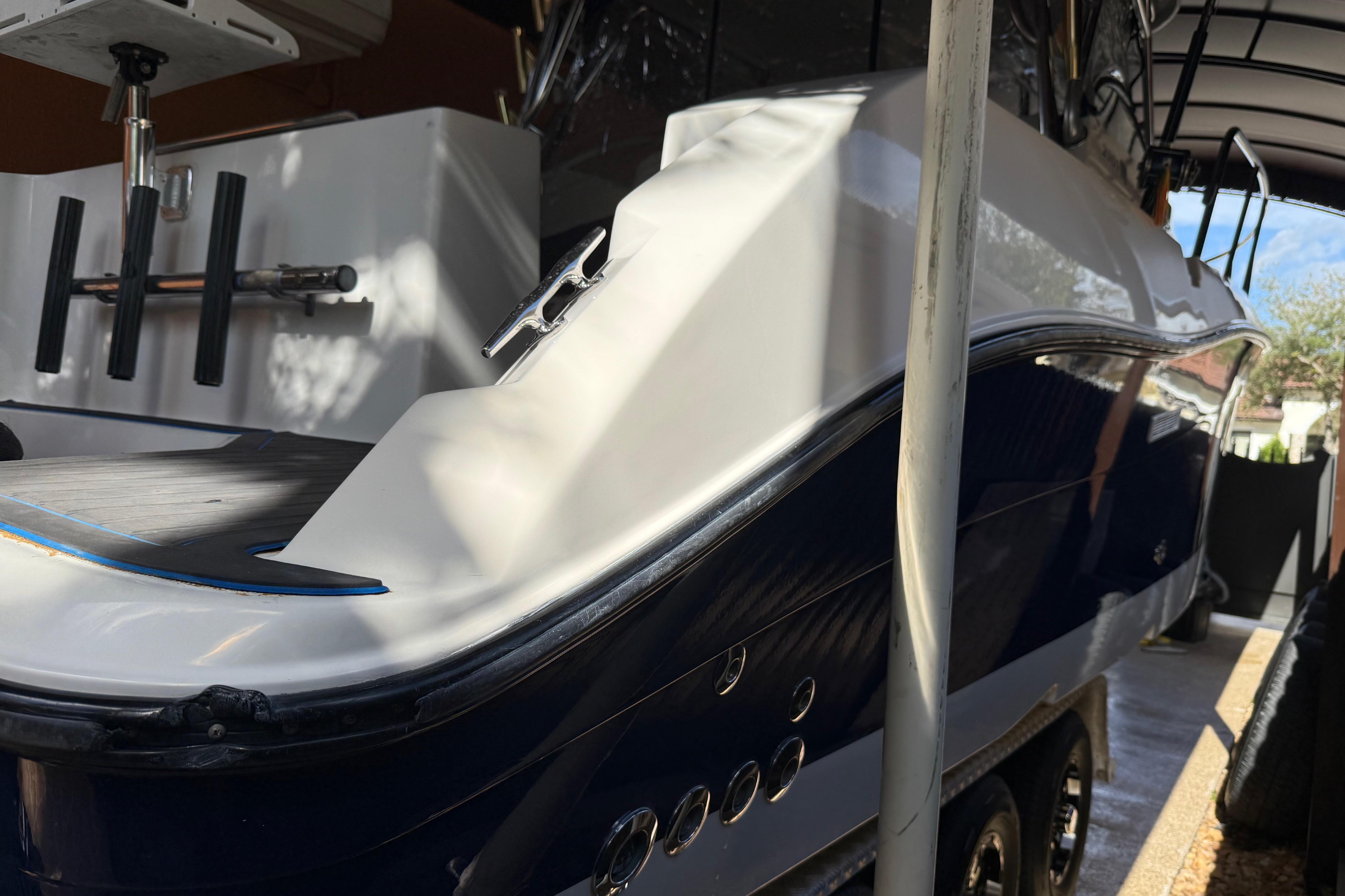 2005 Seaswirl Striper 290 boat in storage, showcasing sleek design and fishing rod holders.