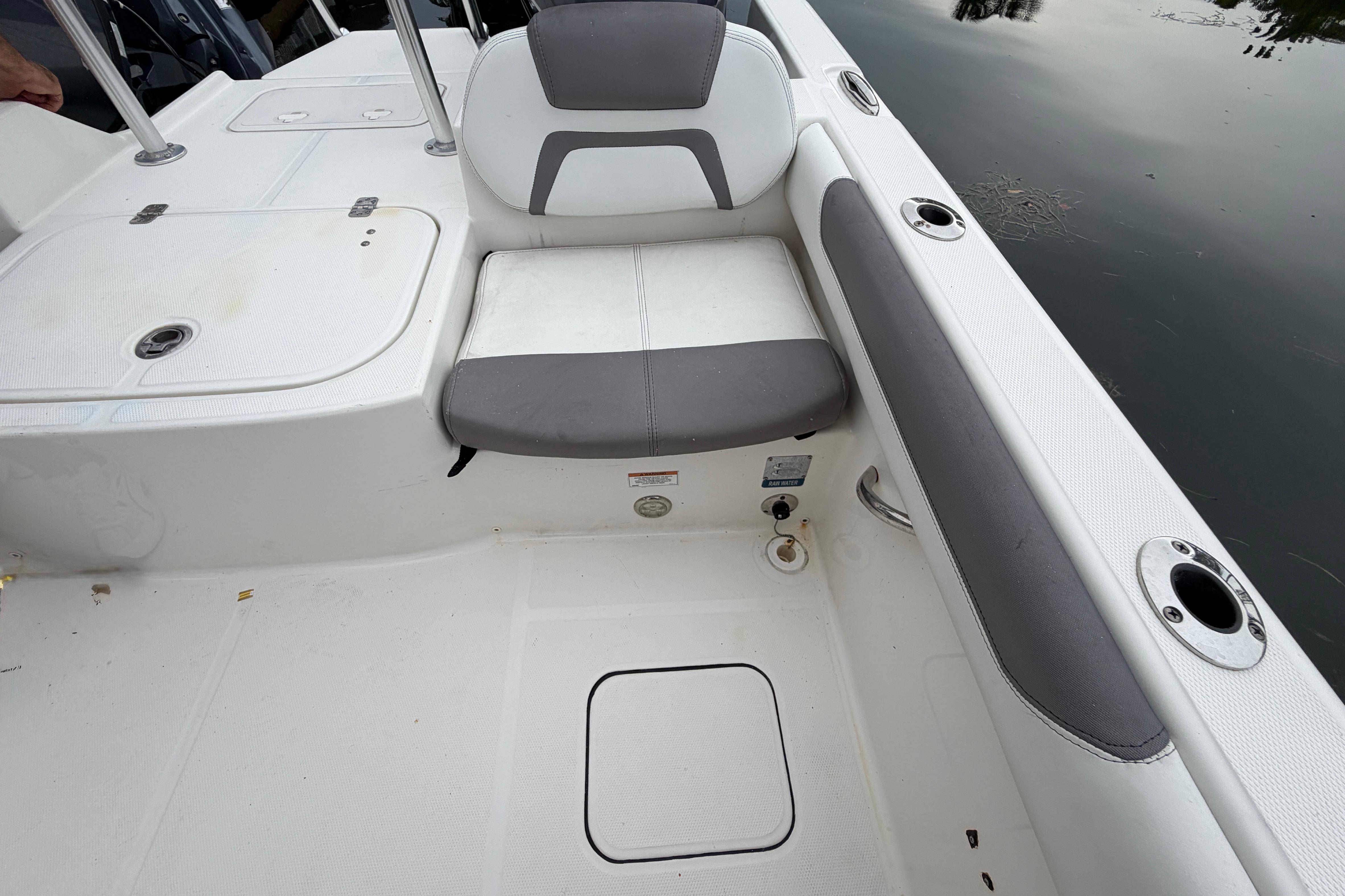 2019 World Cat 230 DC boat interior with seating and storage compartments.