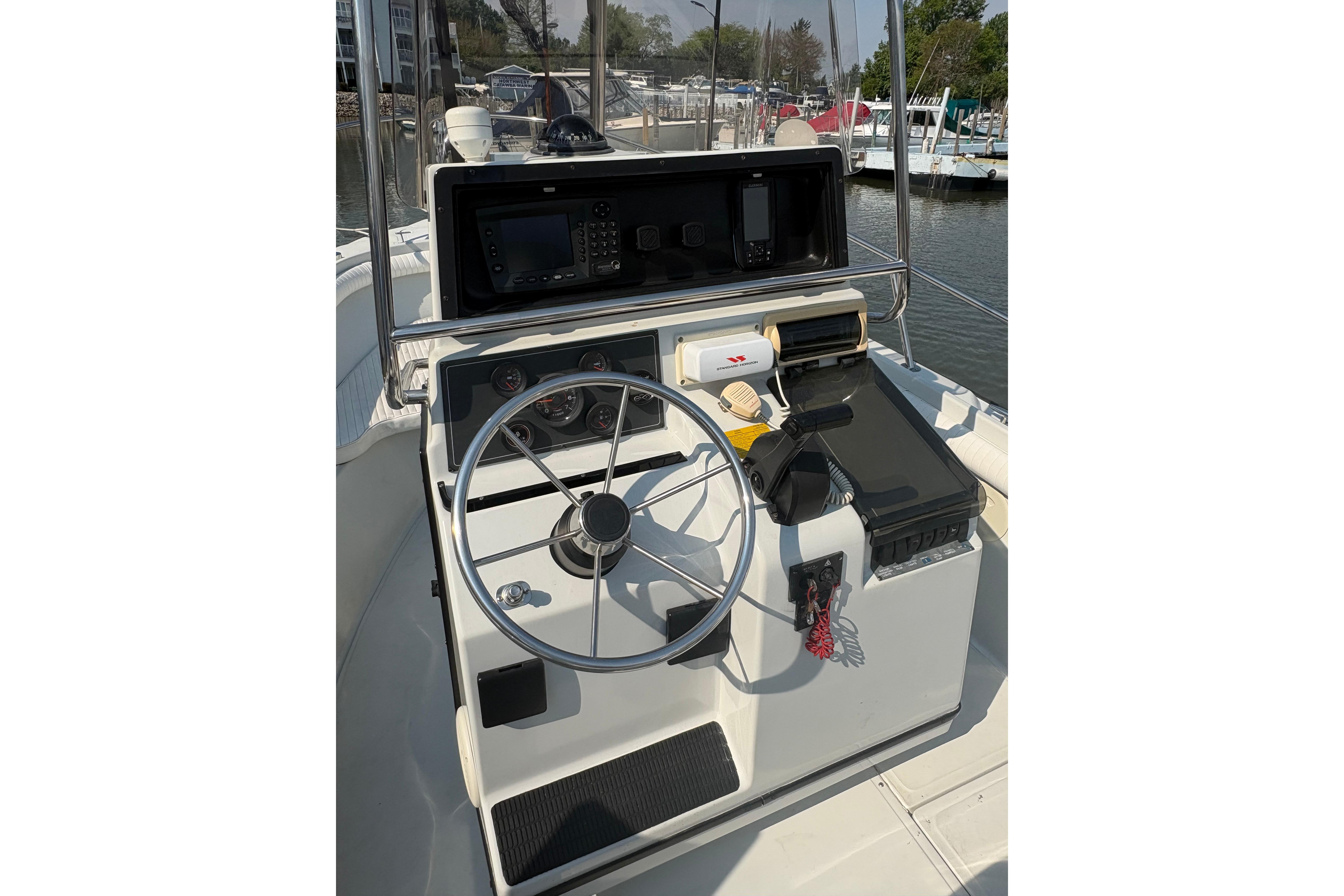 1993 Boston Whaler 21 Outrage boat helm with steering wheel and navigation equipment.