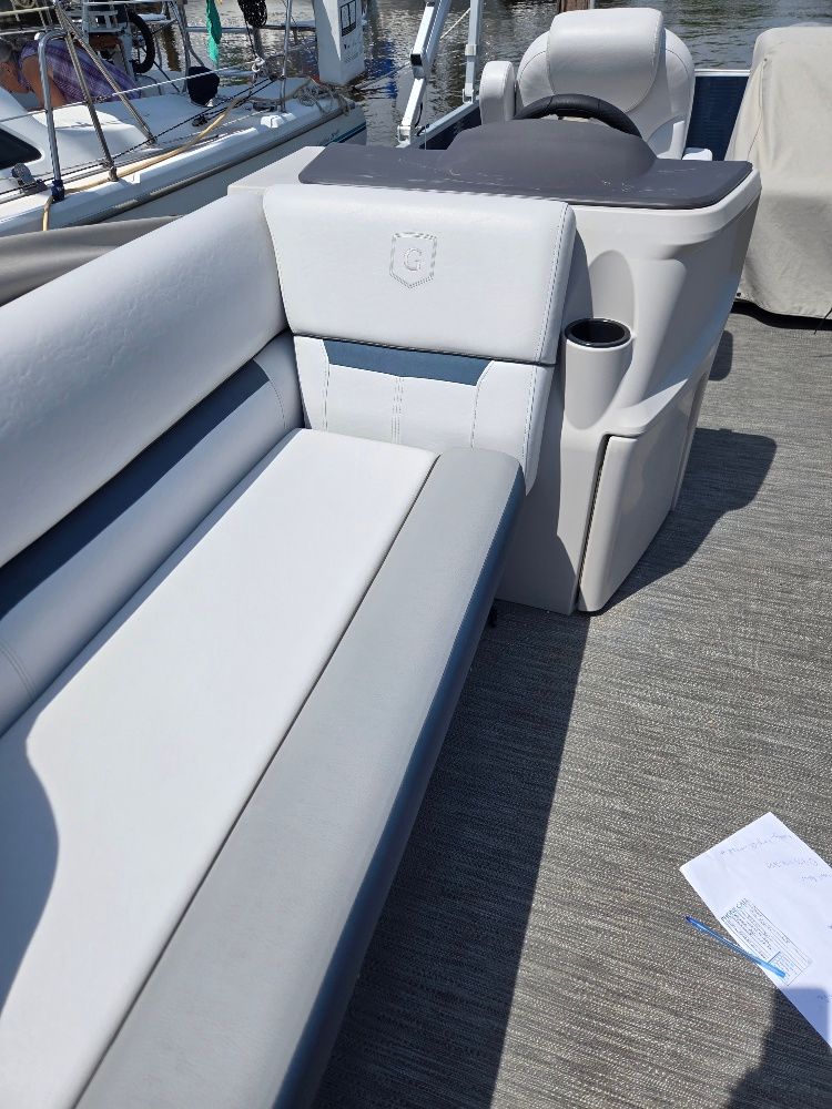 The image shows the interior of a Godfrey Sweetwater 2186C pontoon boat with gray upholstery.