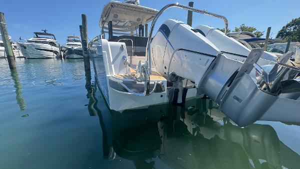 Nimbus T11 2025 boat docked in marina, featuring sleek design and powerful outboard engine.