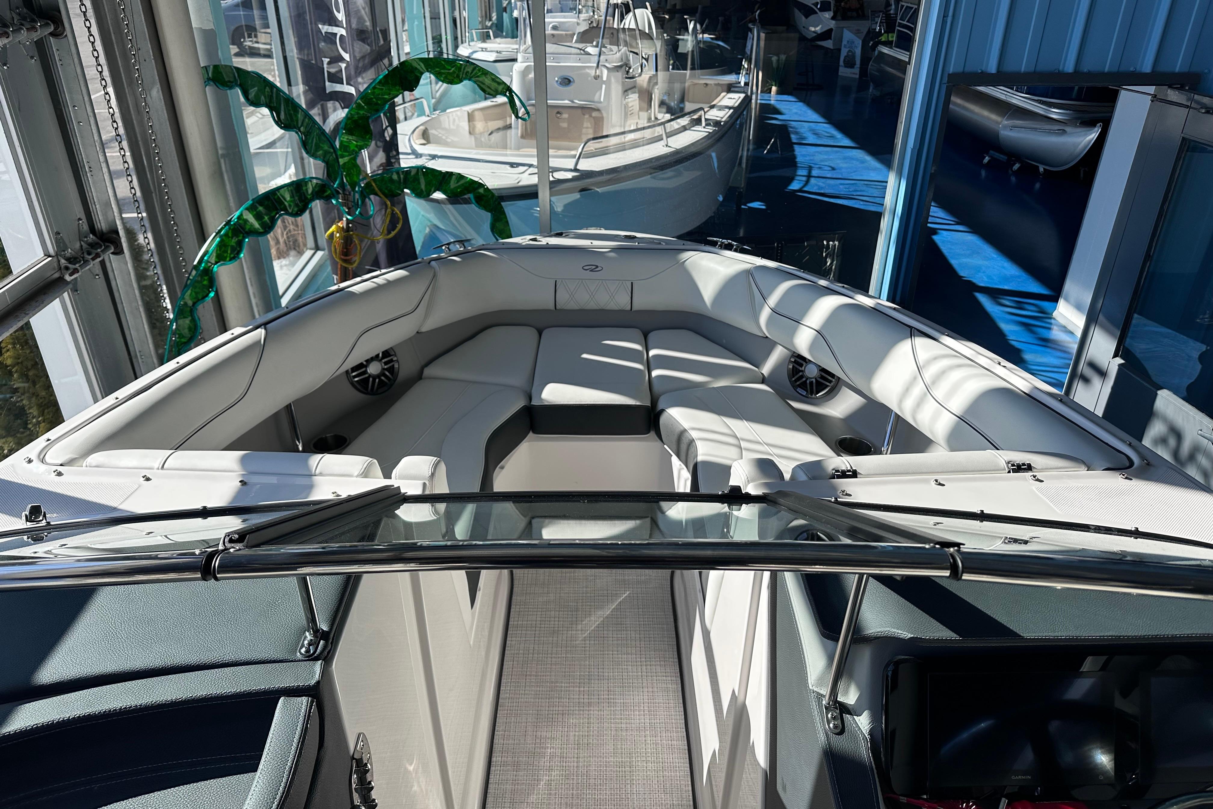2026 Regal LX4 boat interior with plush seating and modern design in showroom.