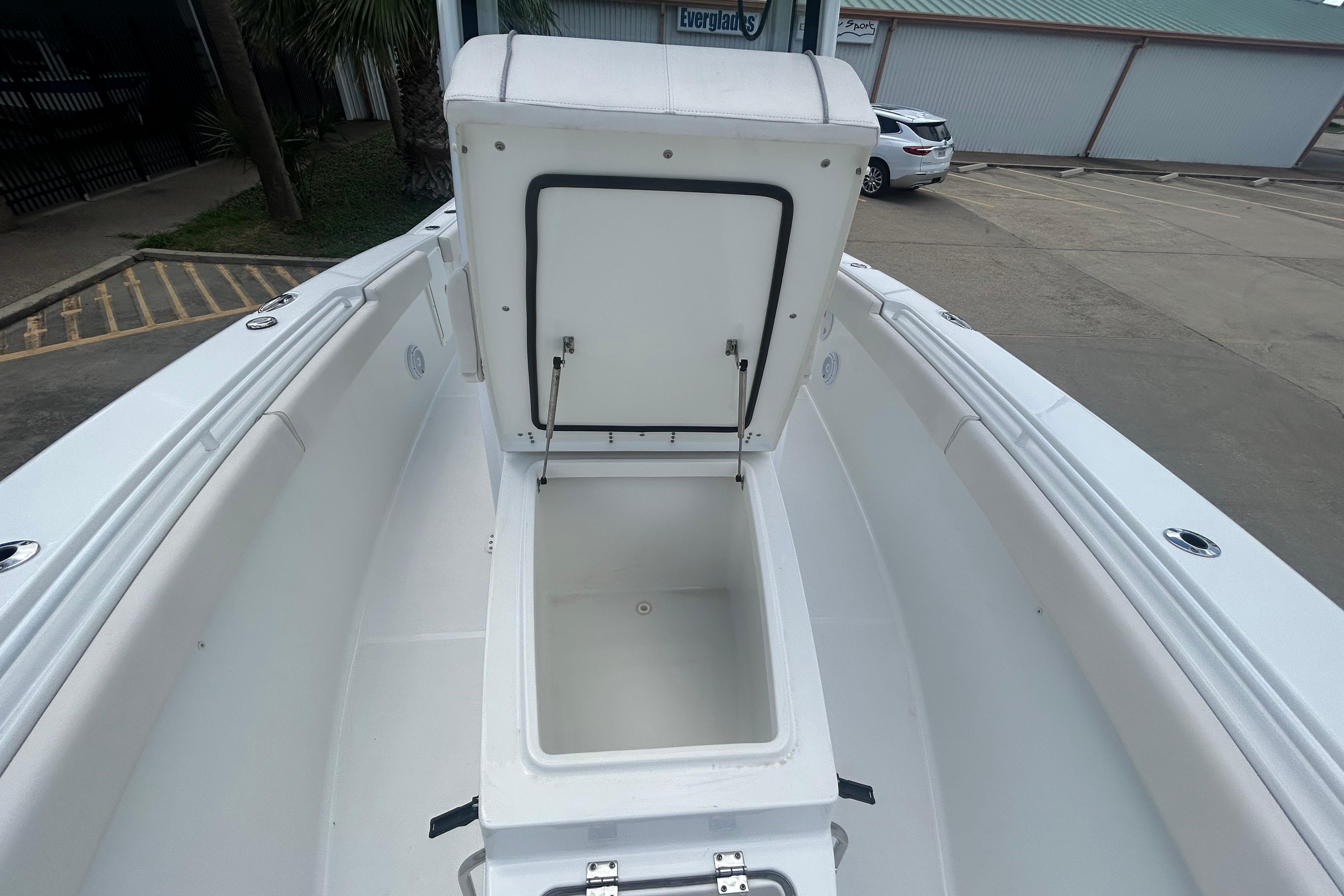 2023 Sea Hunt Gamefish 27 Coffin Box open, showcasing spacious storage on a sleek boat deck.