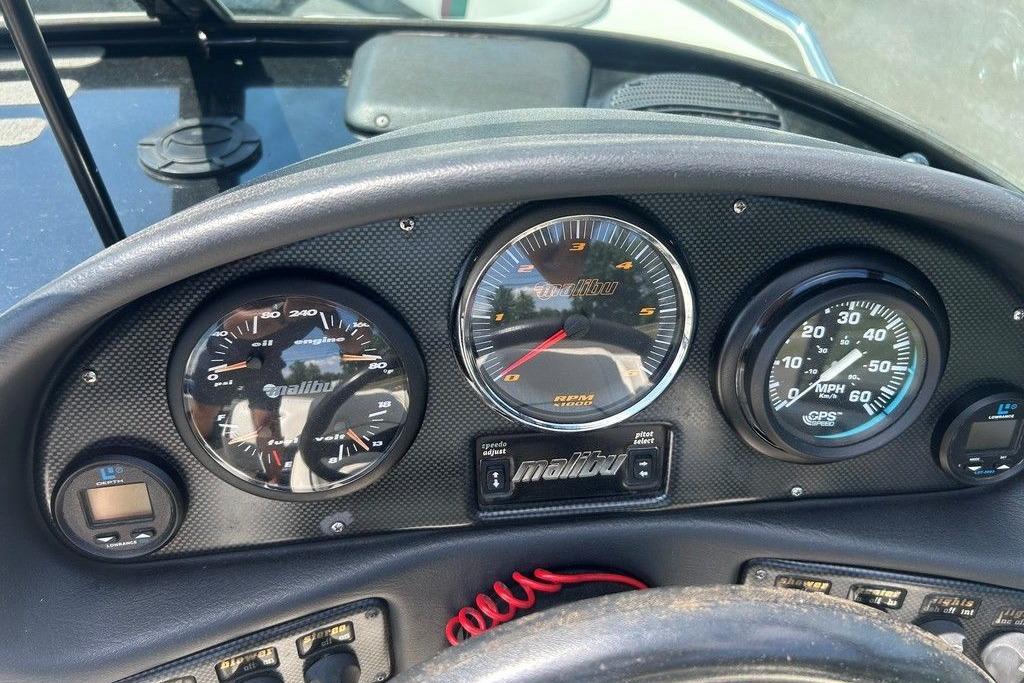 Dashboard of a 1999 Malibu Response boat with gauges and controls.