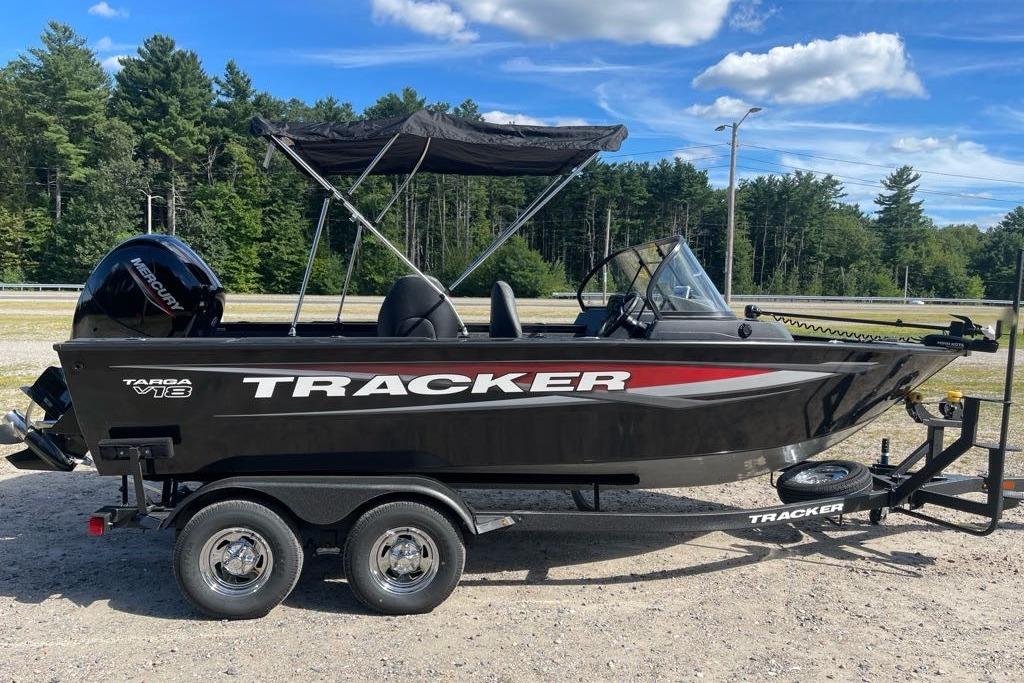 2026 Tracker Targa V-18 WT boat on trailer, parked outdoors under blue sky.