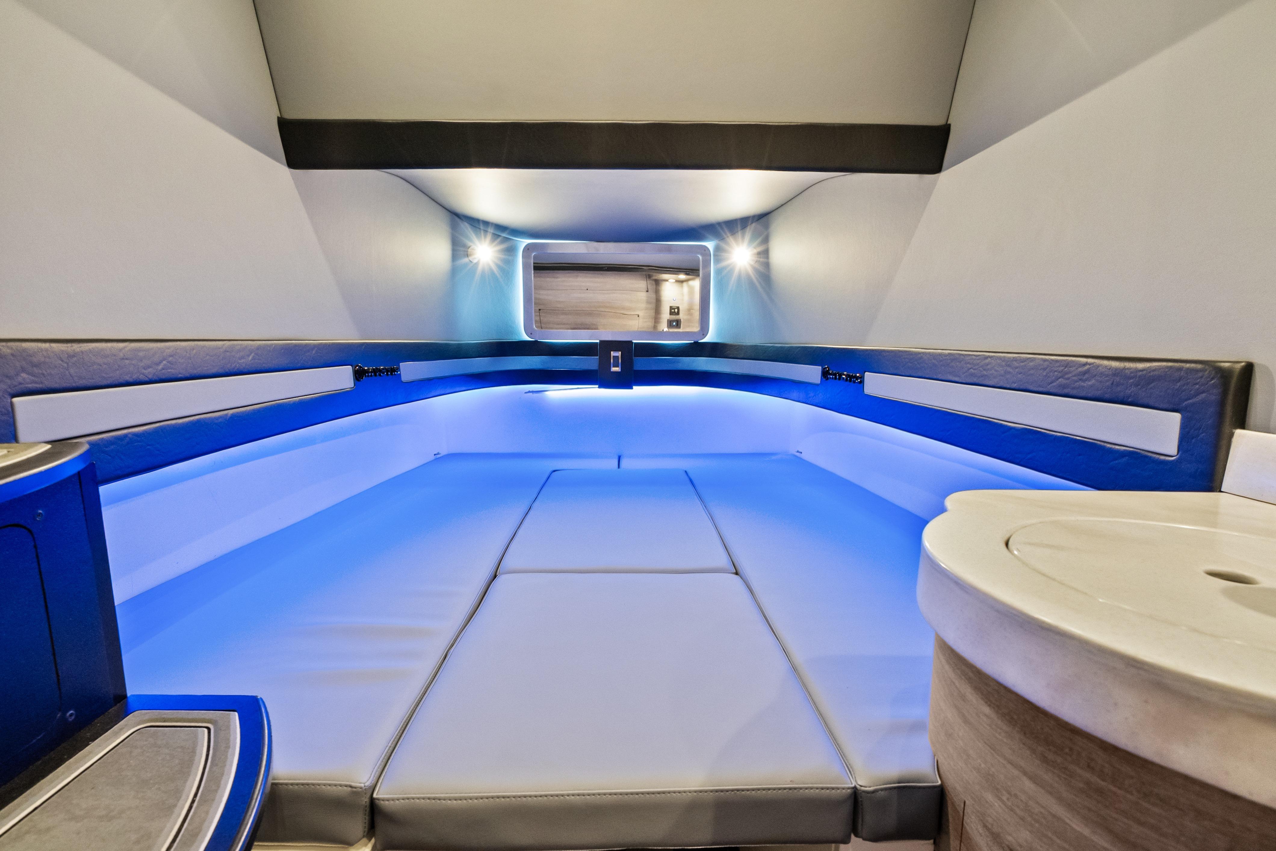 Luxurious interior of 2027 Mystic Powerboats M4200 with ambient blue lighting.