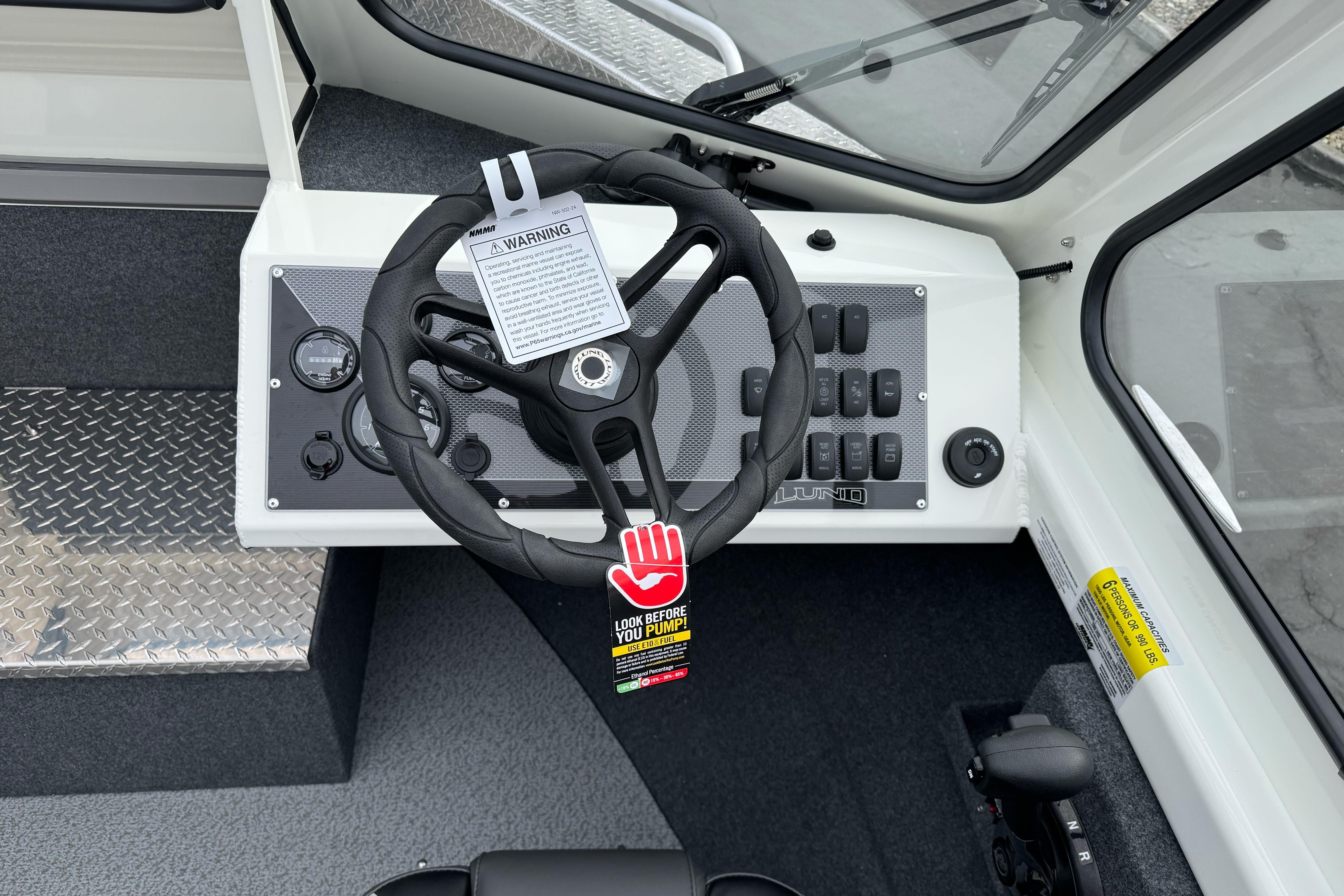 2026 Lund 185 Heavy Gauge boat dashboard with steering wheel and control panel.