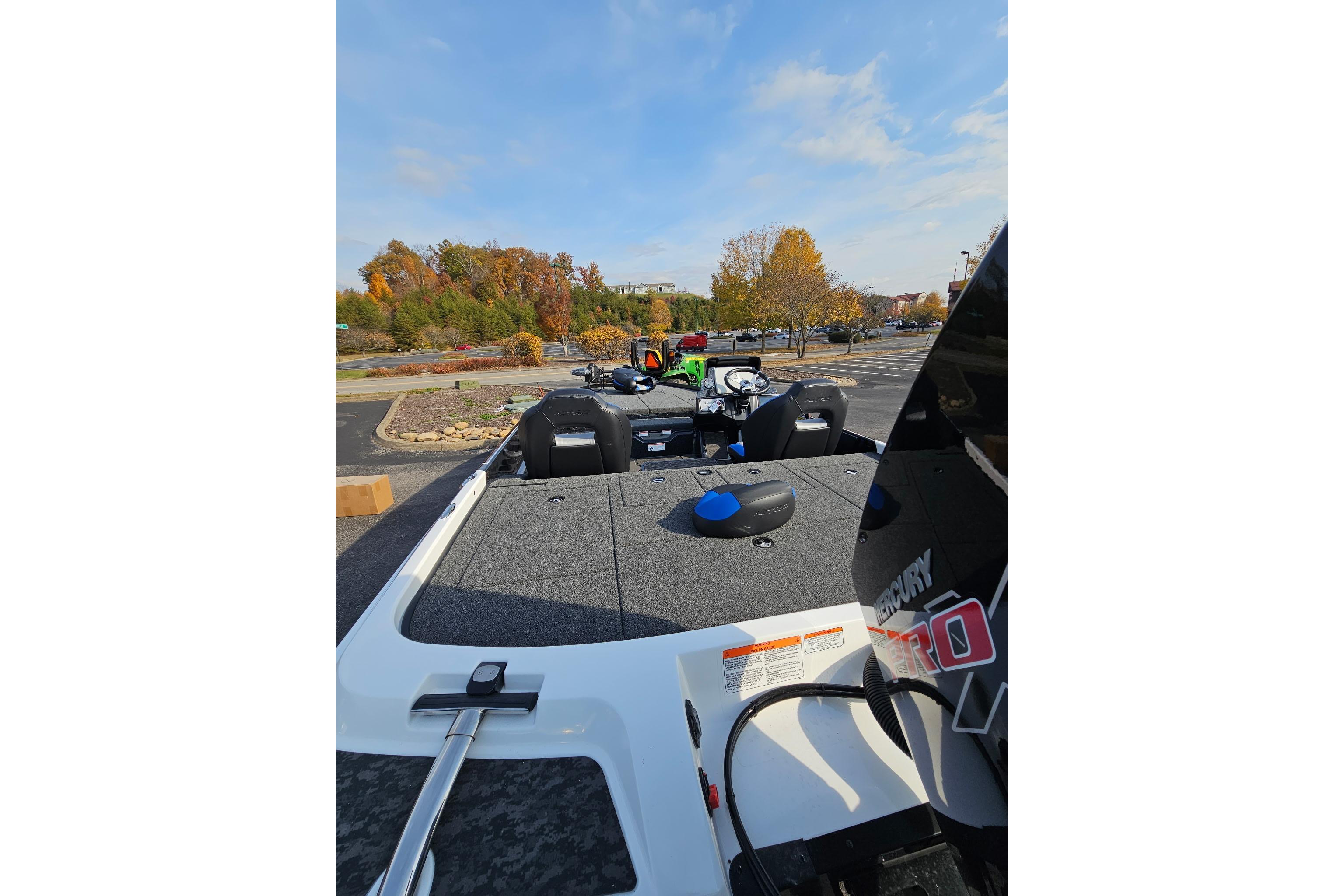 2026 Nitro Z21 XL Pro boat in parking lot, showcasing deck and motor.