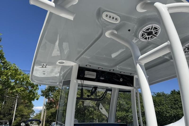 2026 Sea Hunt Gamefish 30 boat's T-top with speakers and rod holders, under clear blue sky.