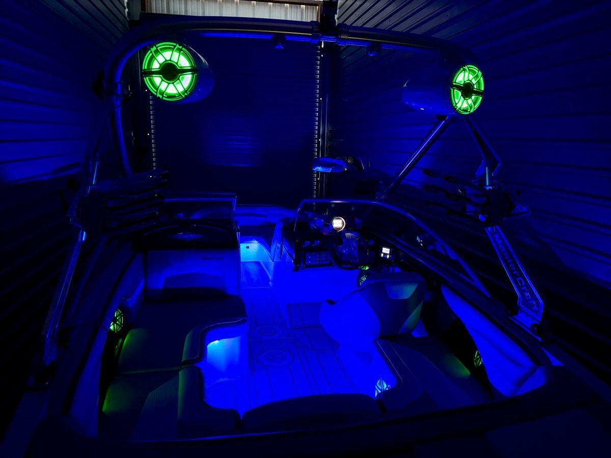 The image shows the interior of a 2008 MasterCraft XStar with blue and green lighting.