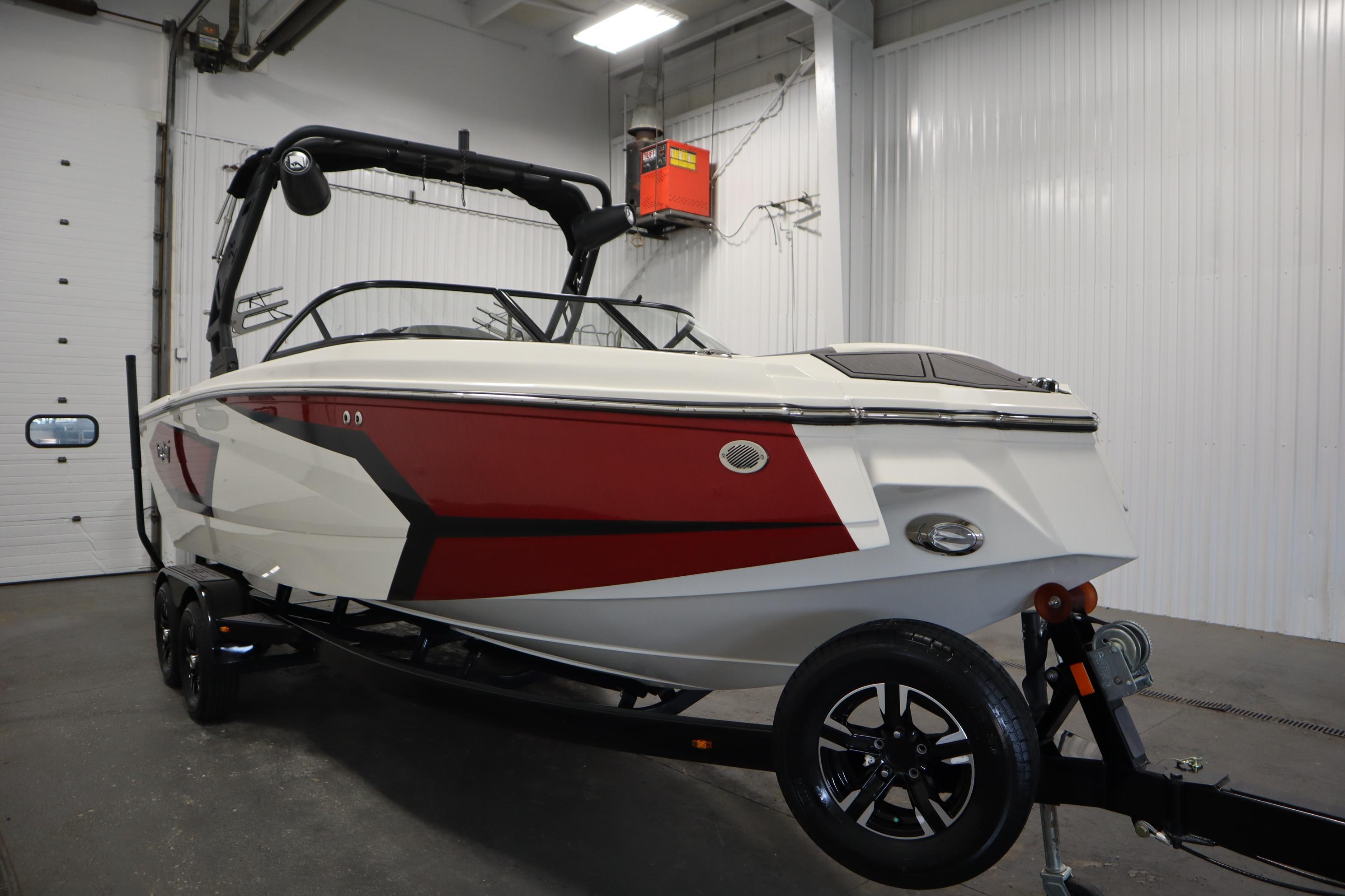 2023 Heyday WT Surf boat with red and white design in a garage setting.