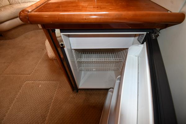 Open mini fridge inside 1997 Sunseeker Camargue 47 yacht interior.