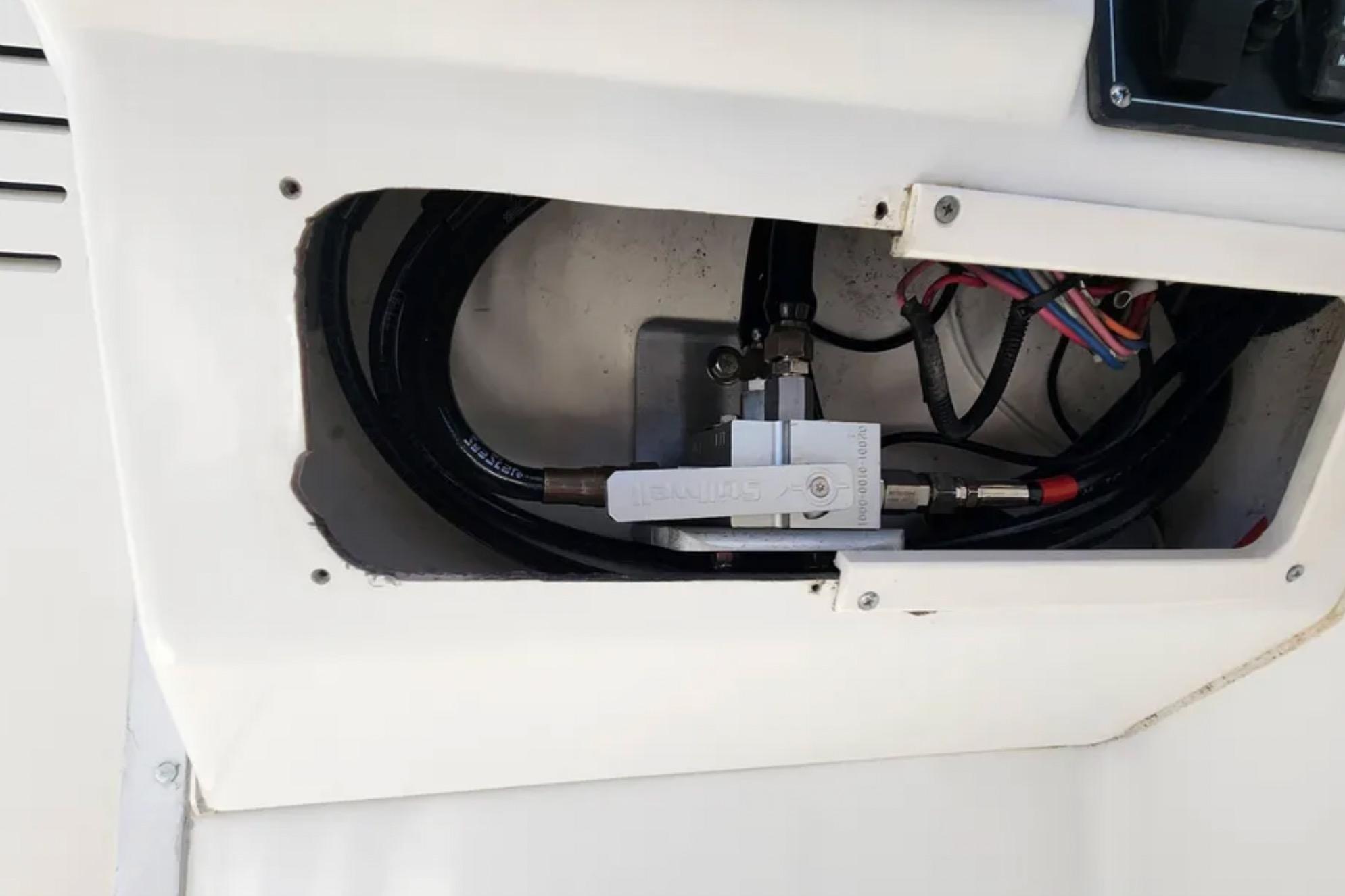 Boat wiring and hydraulic system inside a 2000 Boston Whaler 21 Conquest.