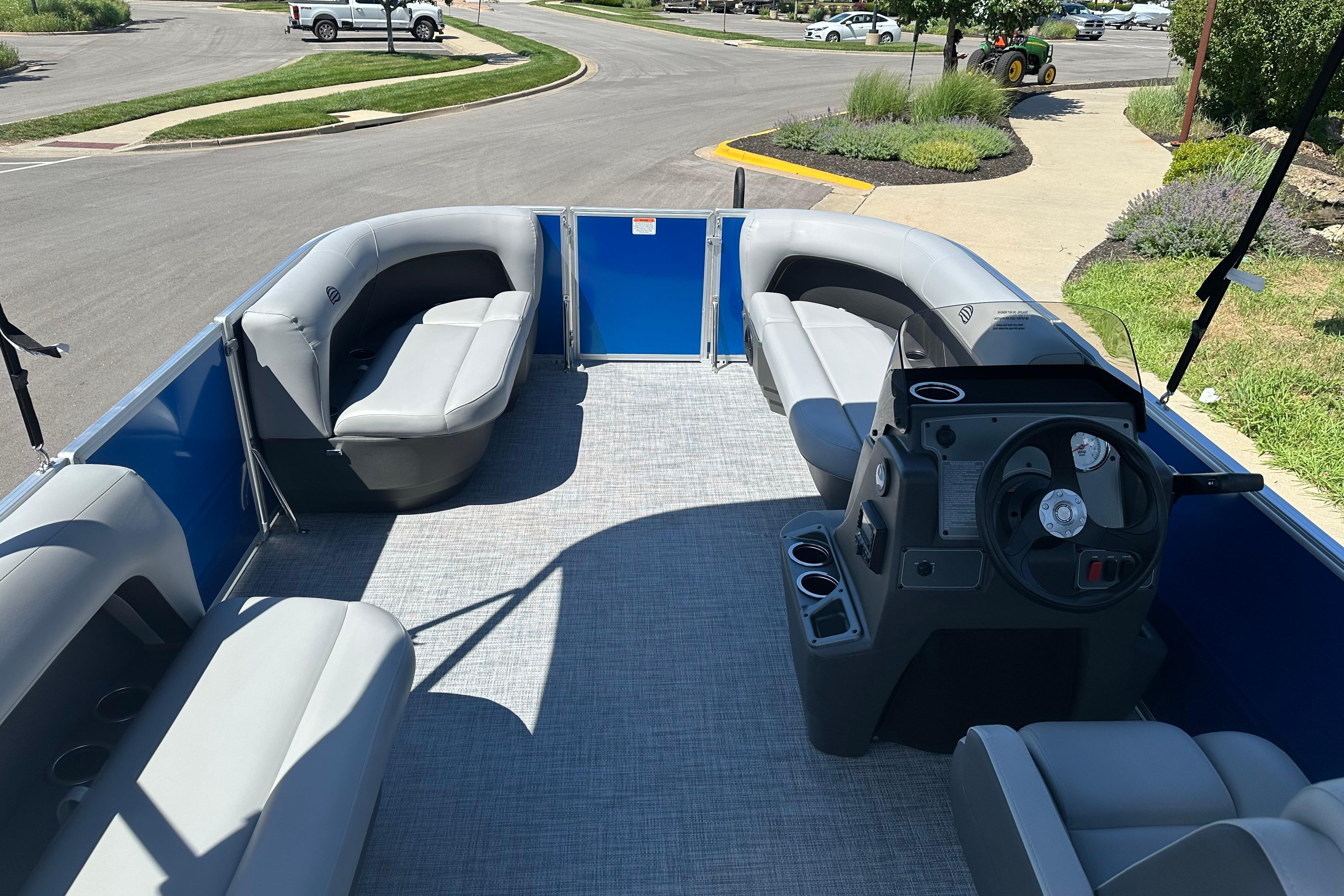 2026 Sun Tracker Party Barge 16 DLX interior with seating and steering console.