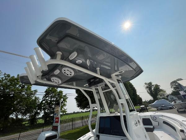 2025 Tidewater 232 CC Adventure boat with T-top under sunny sky.