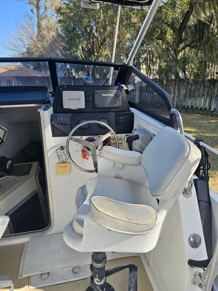 Interior of a 1991 Pro-Line Cuddy Cabin boat with helm console.