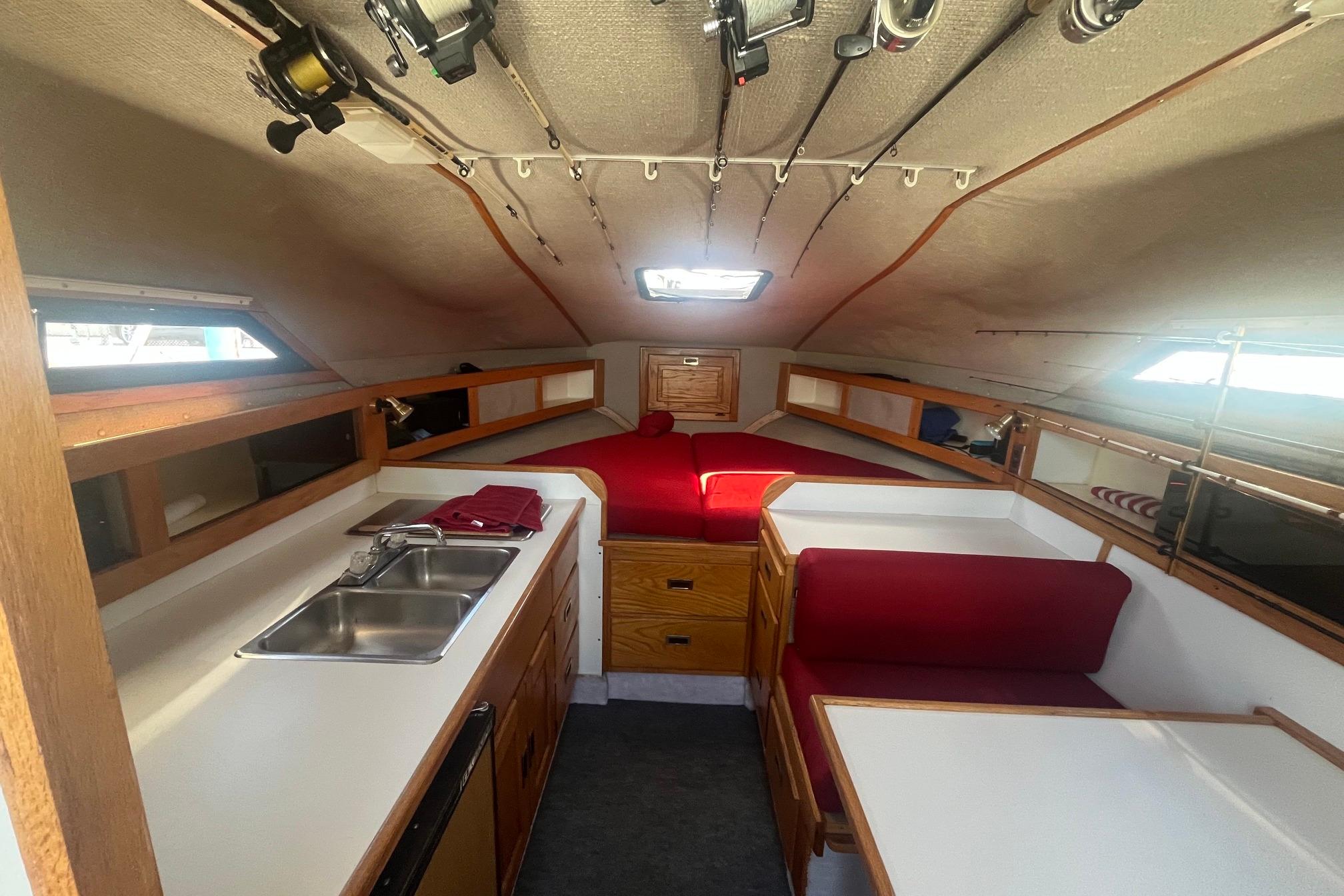 Interior of 1988 Seafox 29 Flybridge boat with kitchen and seating area.