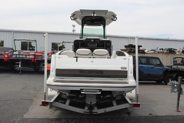 2023 Scarab 255 Open ID boat on trailer, rear view in a parking lot.