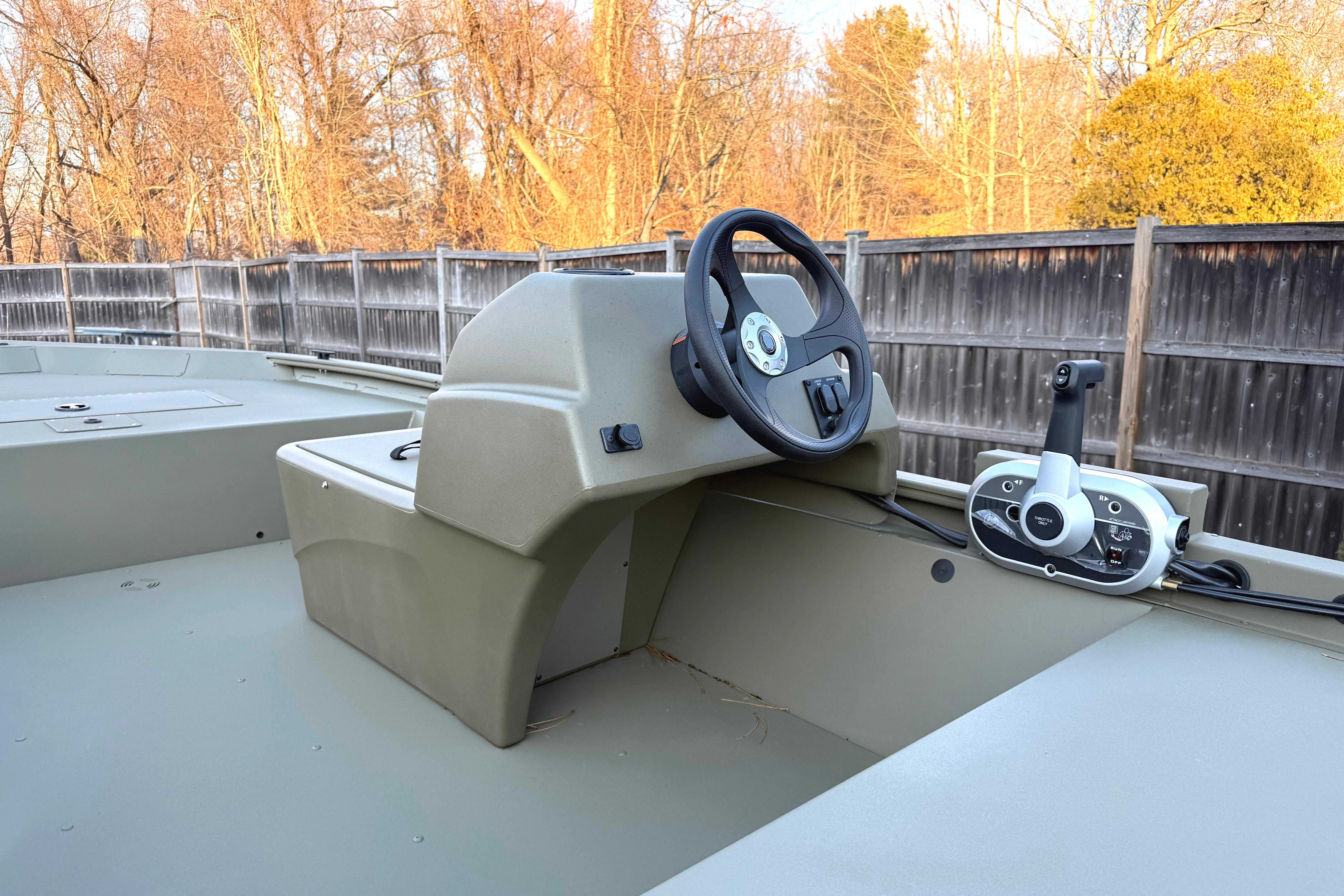 2026 Tracker Grizzly 1648 SC boat interior with steering wheel and control panel.
