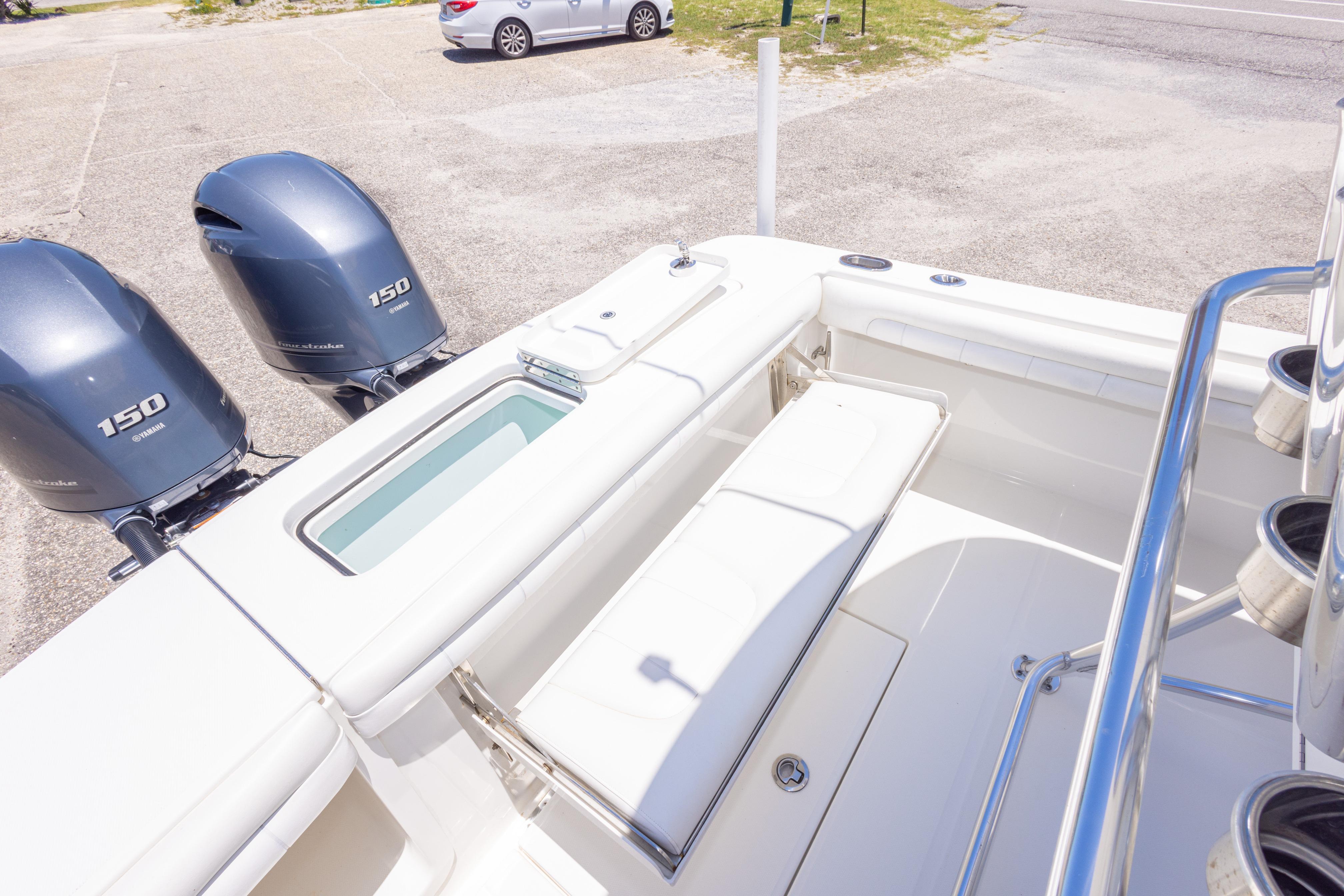 2019 Regulator 23 Center Console boat with twin Yamaha 150 engines, docked on a sunny day.